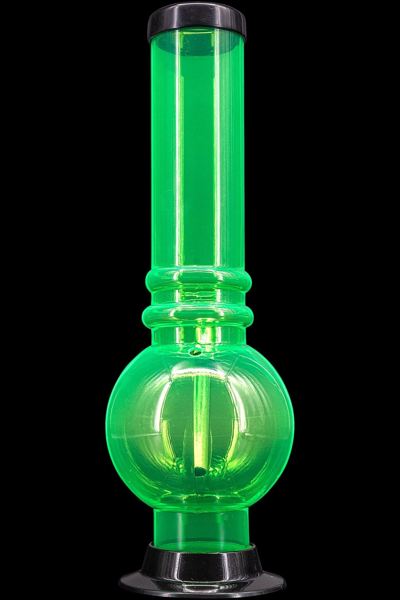 Glowing green glass water pipe isolated on black.