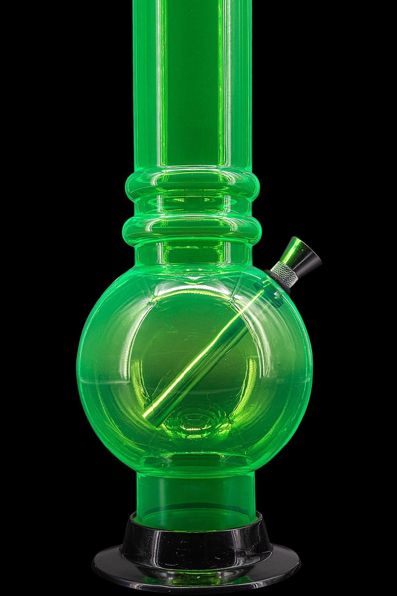 Green glass water pipe (bong) isolated on a black background.