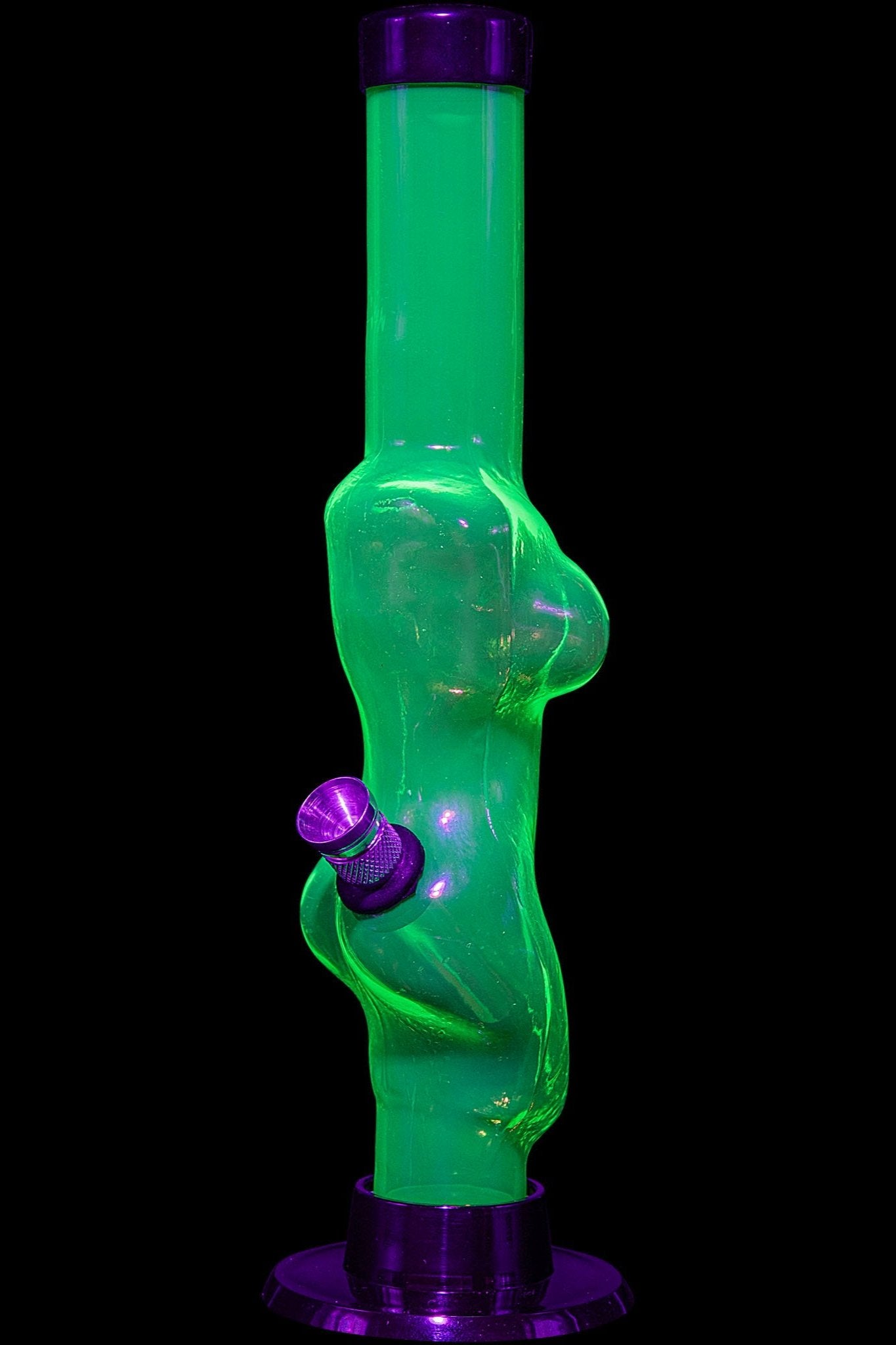 Glowing green glass bong with a female form silhouette, against a black background.