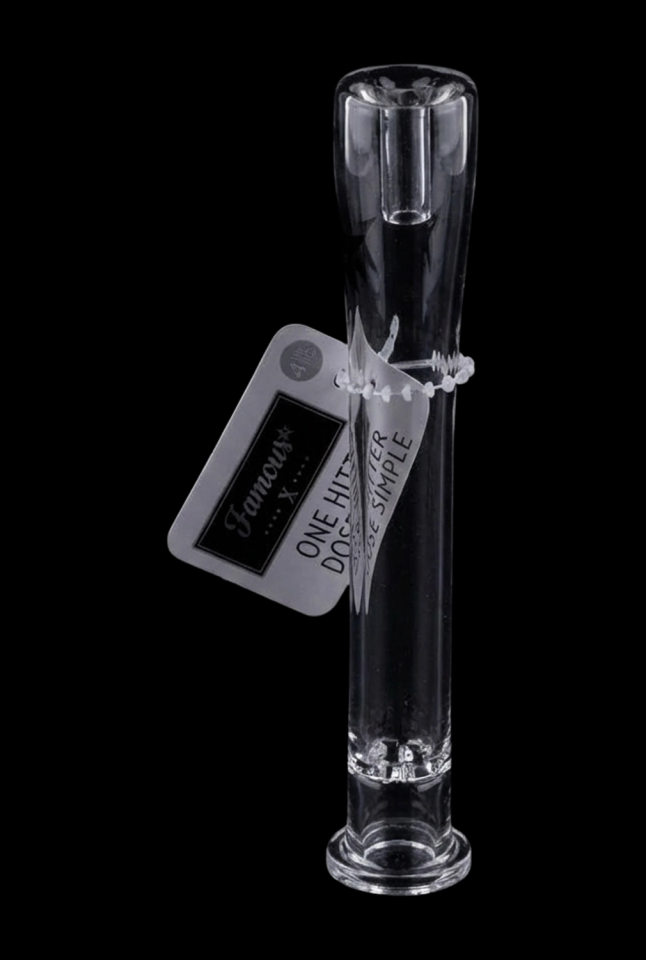 Center-lit vertical view of the clear 4in Famous X-One Hitter-Clear-4in standing against a black background with its hang tag attached.