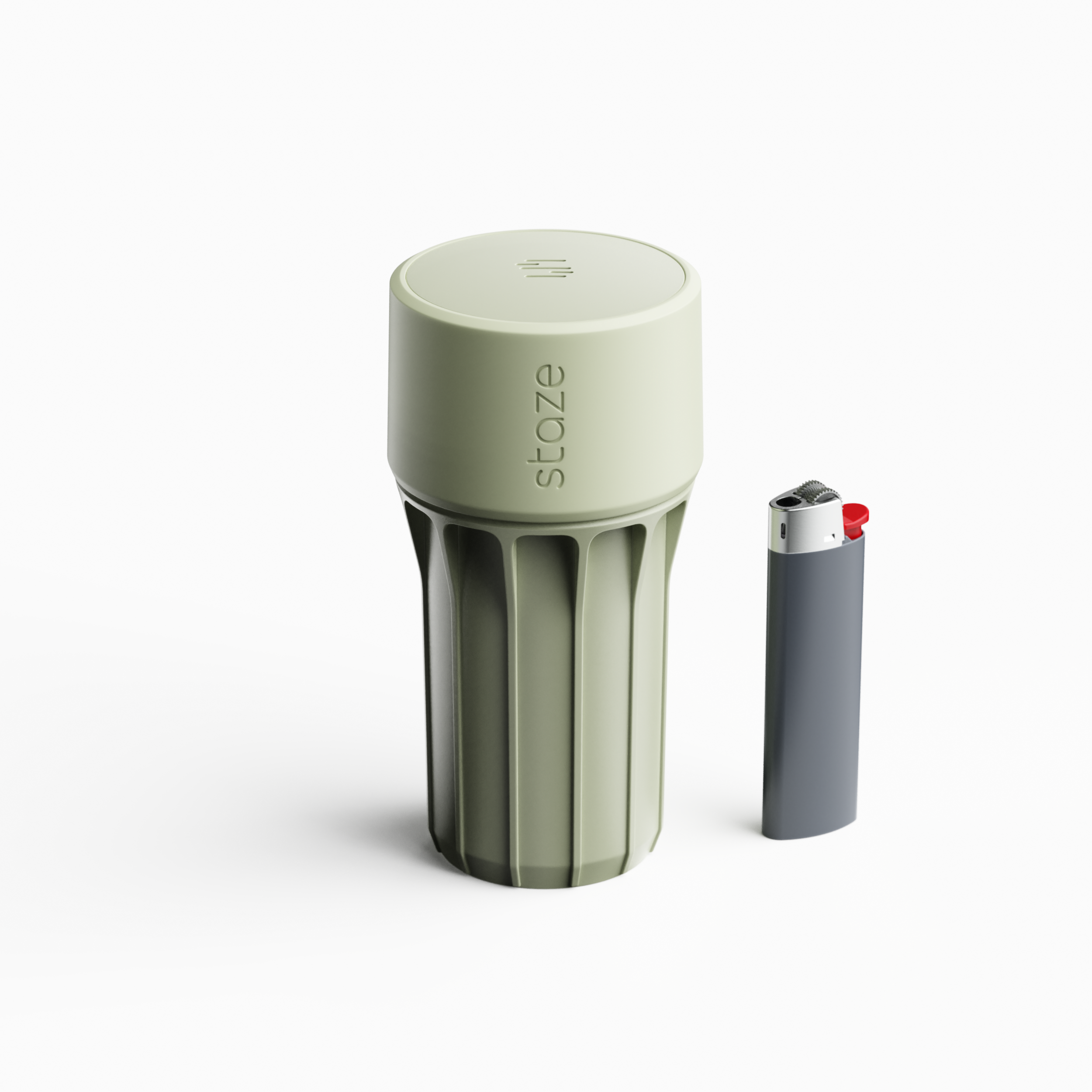 Close-up of the pale green STAZE PRESERVE cap from above, showing its recessed top logo and ribbed cylindrical body next to a lighter.