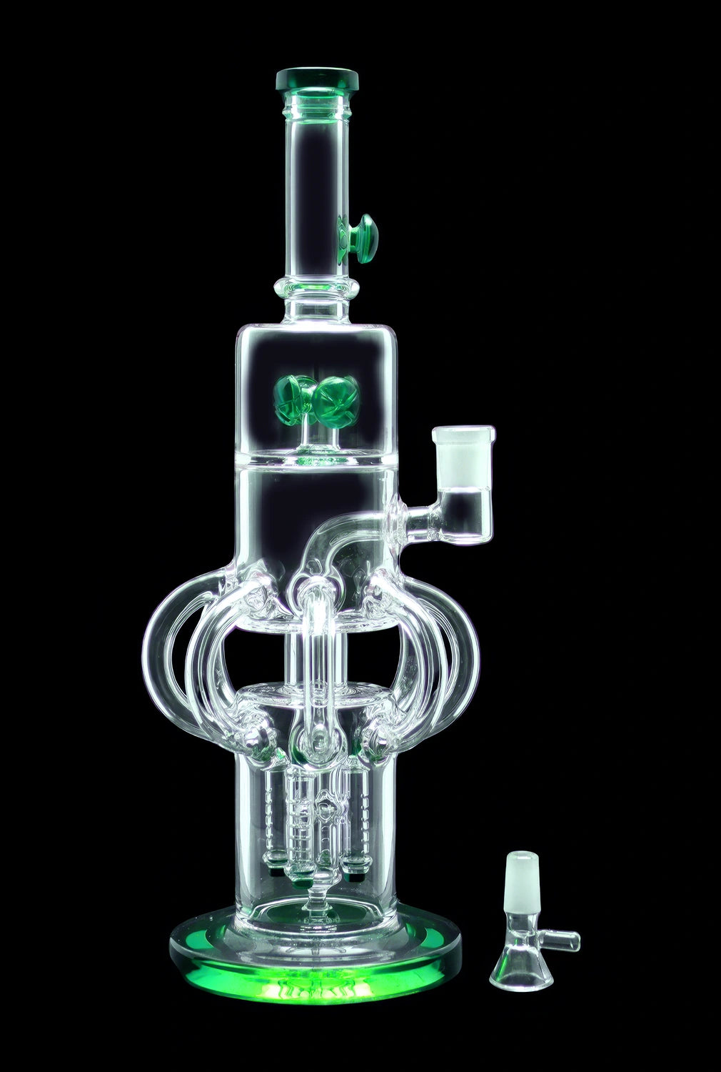 Green-illuminated glass water pipe (bong) with intricate perculator design and separate glass bowl.