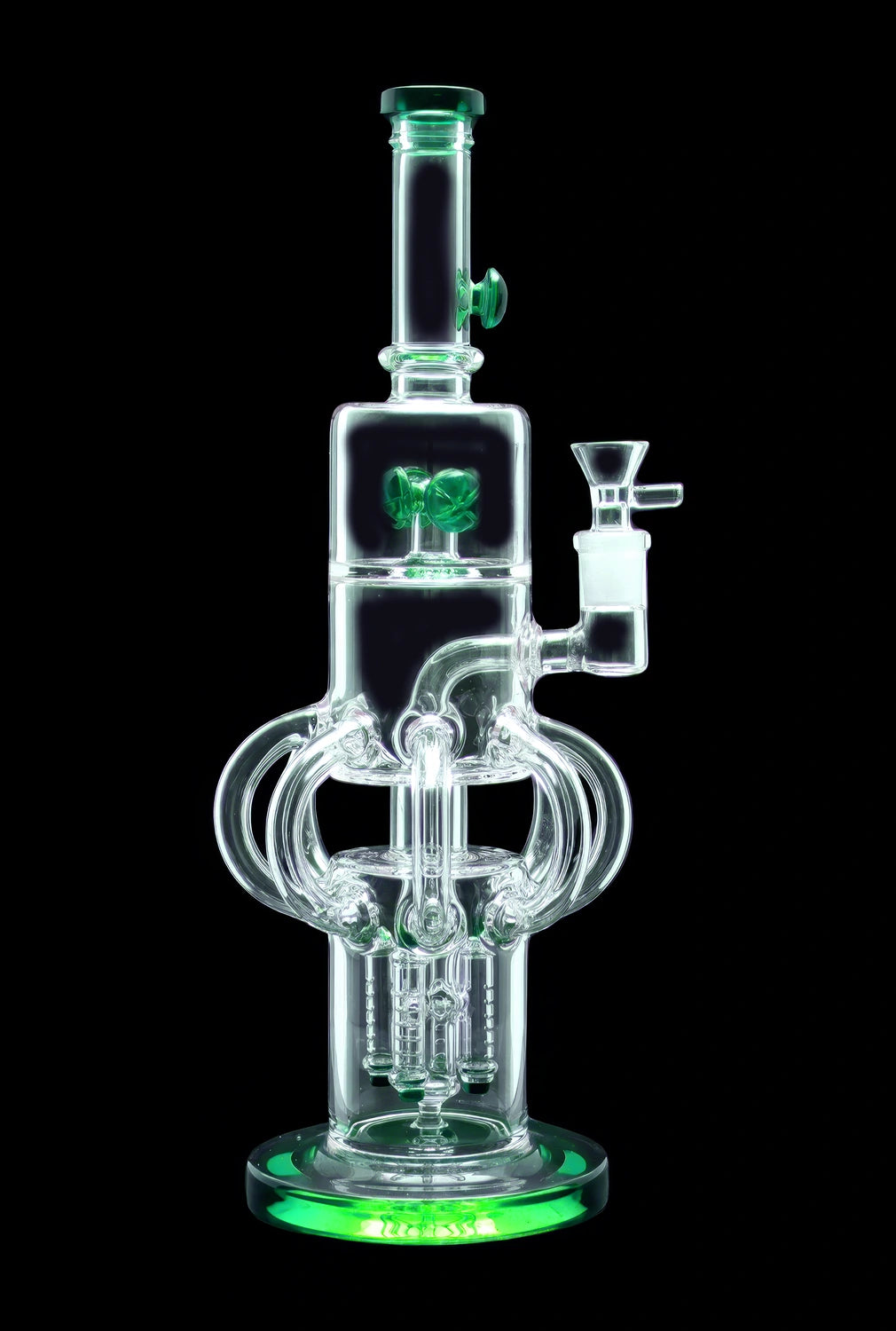 Clear glass water pipe (bong) with green accents and intricate bubbler design, studio shot on black background.