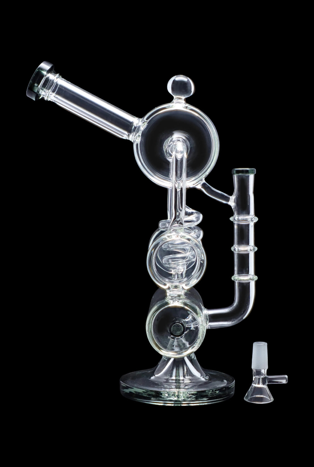 Clear glass water pipe (rig) with multiple chambers and a separate glass bowl, isolated on a black background.