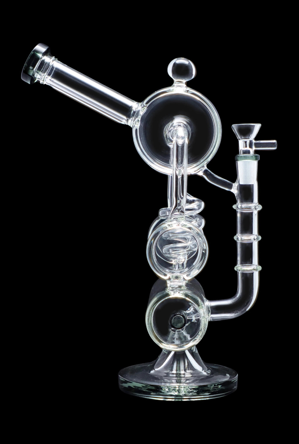 Clear glass water pipe (rig) with multiple chambers and intricate design, isolated on a black background.