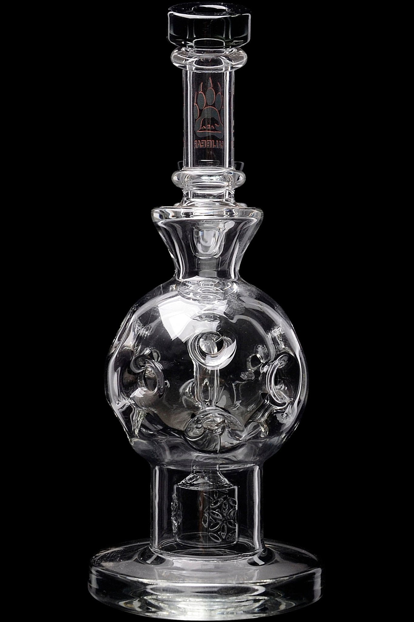 Clear glass water pipe with sculpted skull inside spherical chamber, studio shot.