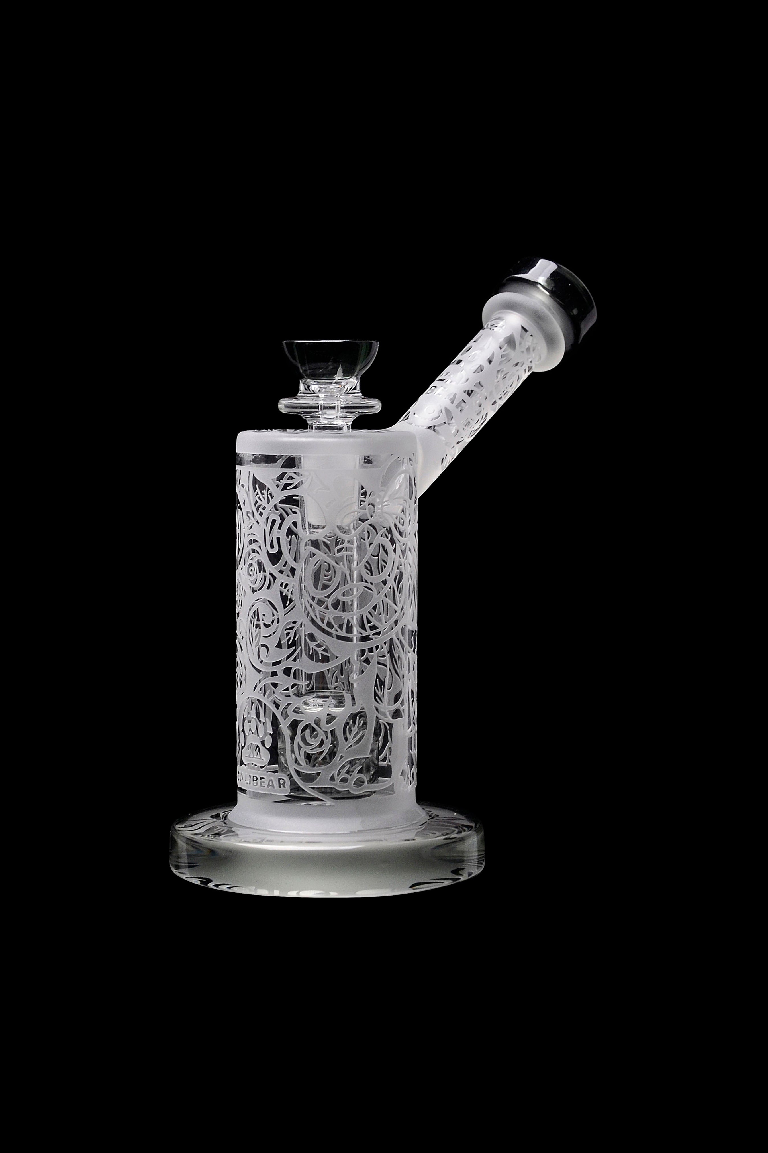 Intricate glass water pipe (rig) with floral lattice design, isolated on a black background.