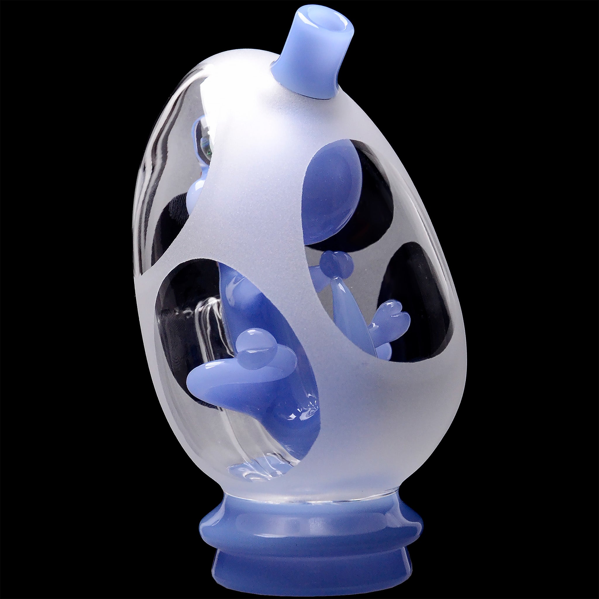 Close-up angled view of the Glassic Frosted Dino Egg Puffco Peak Glass Attachment showing milky blue frosted and clear glass surfaces against a black background.