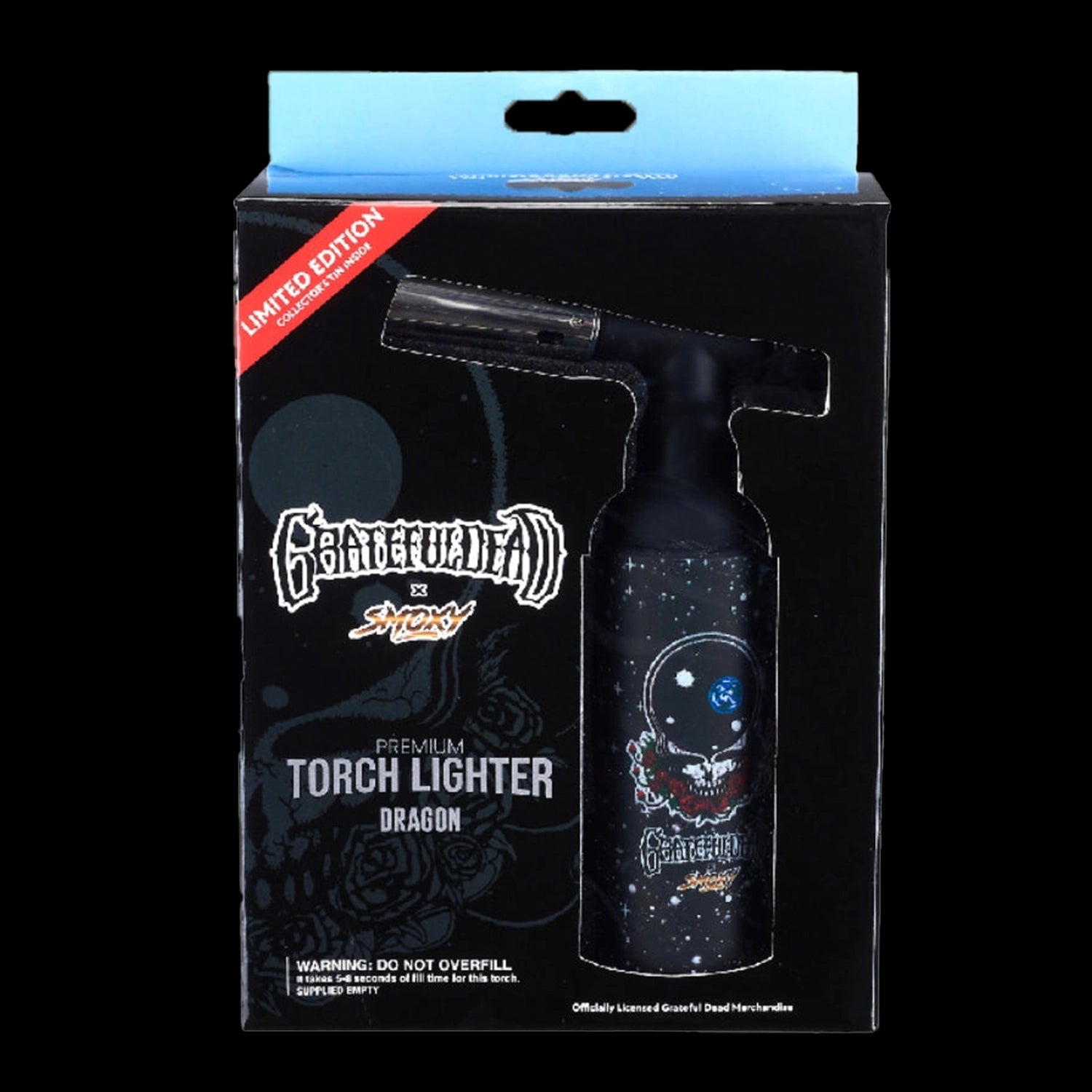 Front-facing product shot of the Grateful Dead Dragon Torch in its black retail packaging showing the torch's angled nozzle and skull-and-space artwork.