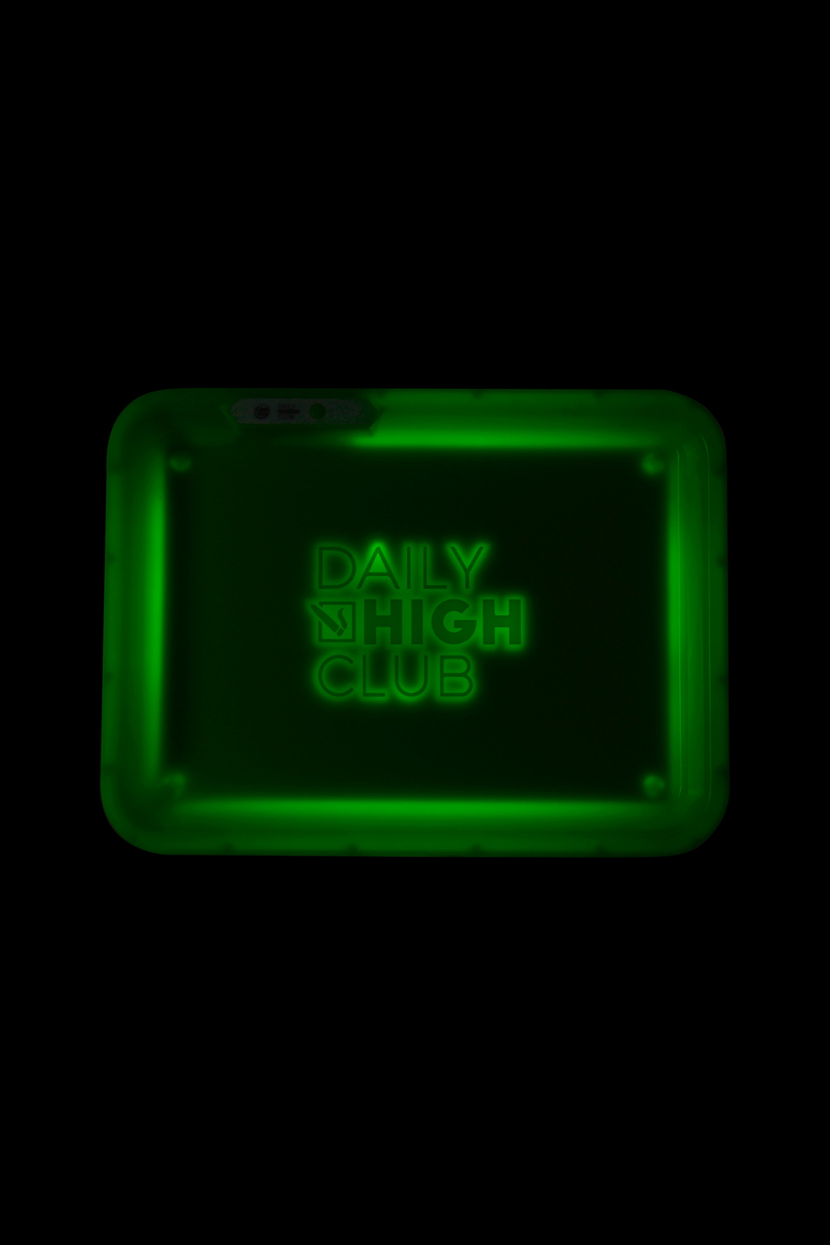 Green rolling tray with “Daily High Club” illuminated in neon lettering.