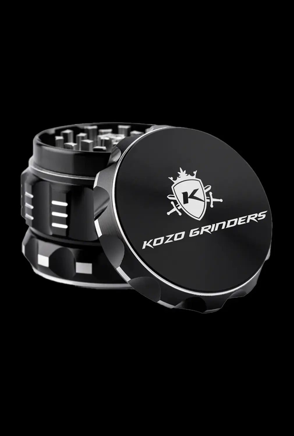 A close-up, angled view of the Kozo Grinder 2| featuring a metallic, multi-tiered design against a dark background.