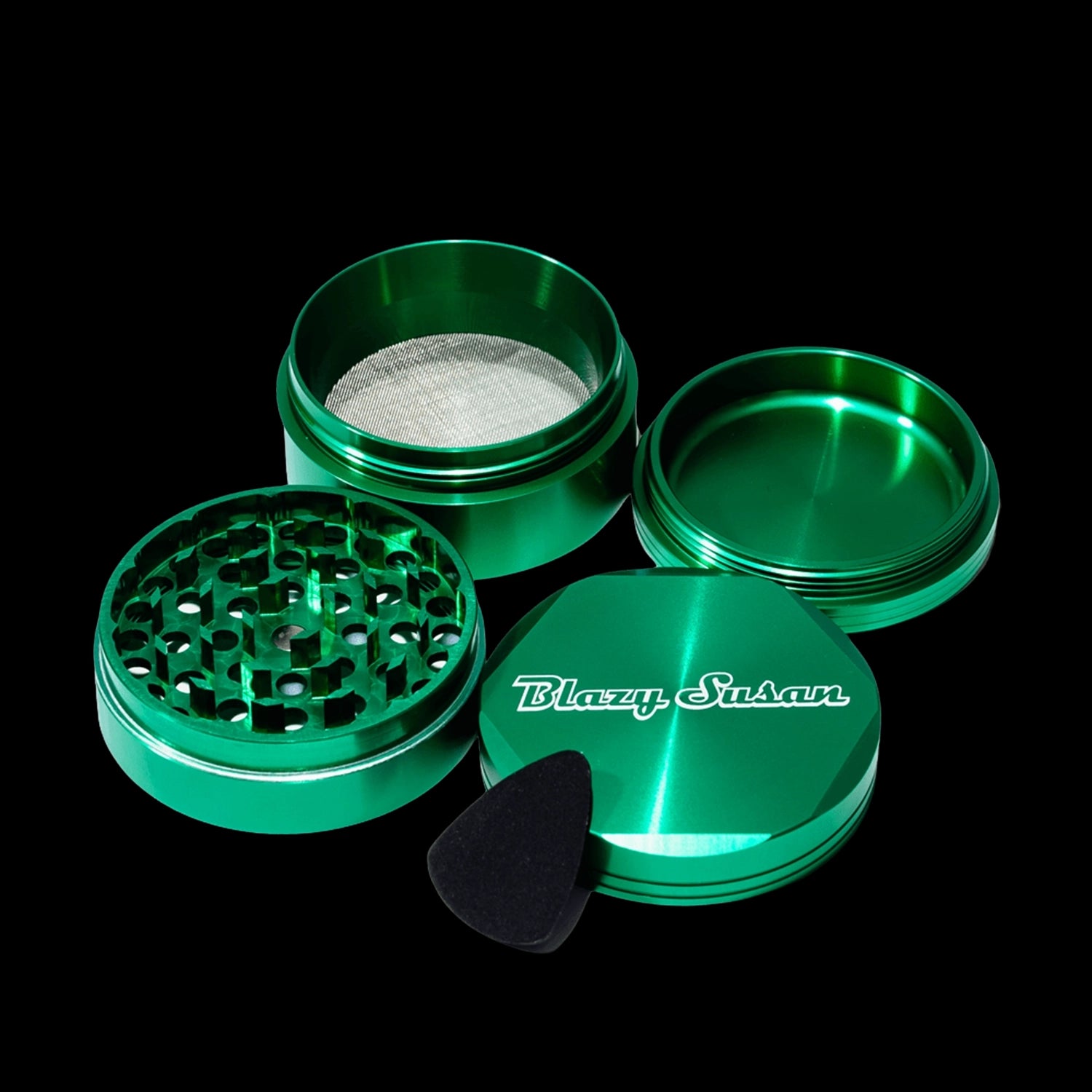 Close-up of a metallic green, disassembled Blazy Susan 4-pc 3 Chamber Grinder shown from a slightly elevated angle against a black background.