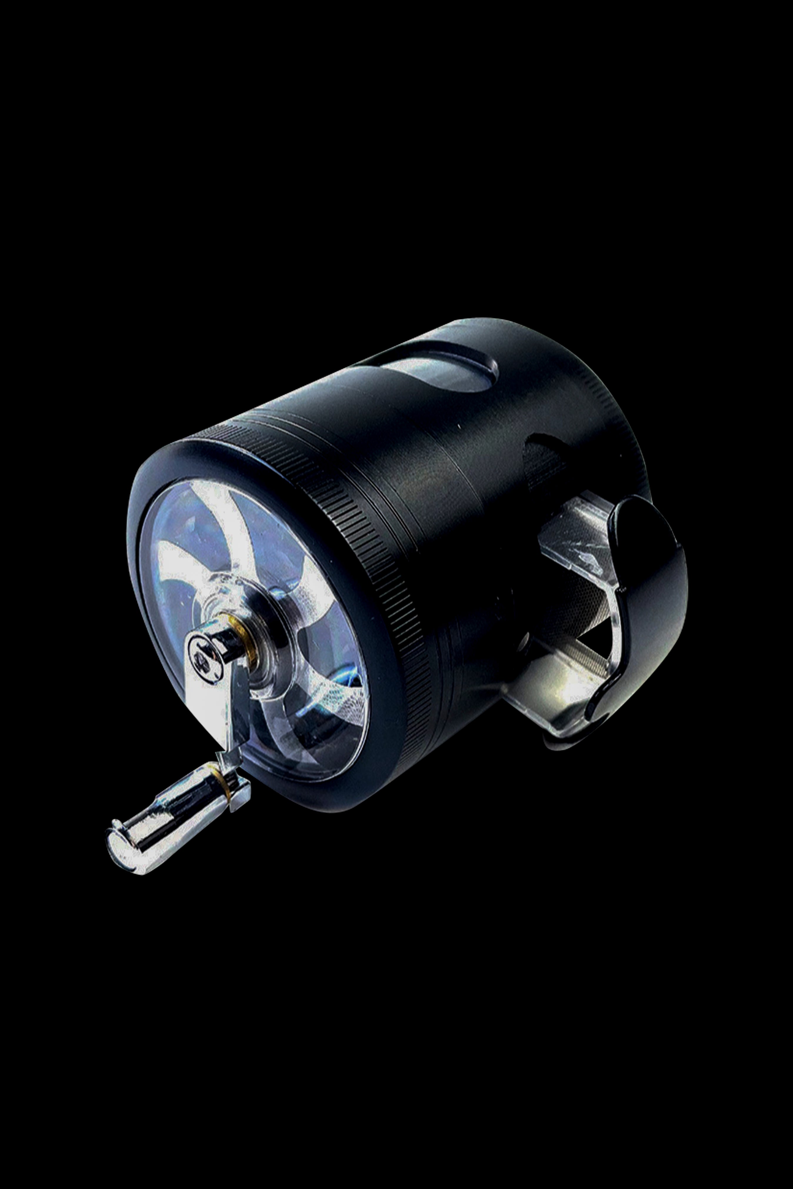 Black cannabis grinder with transparent chambers, showcasing ground herb.