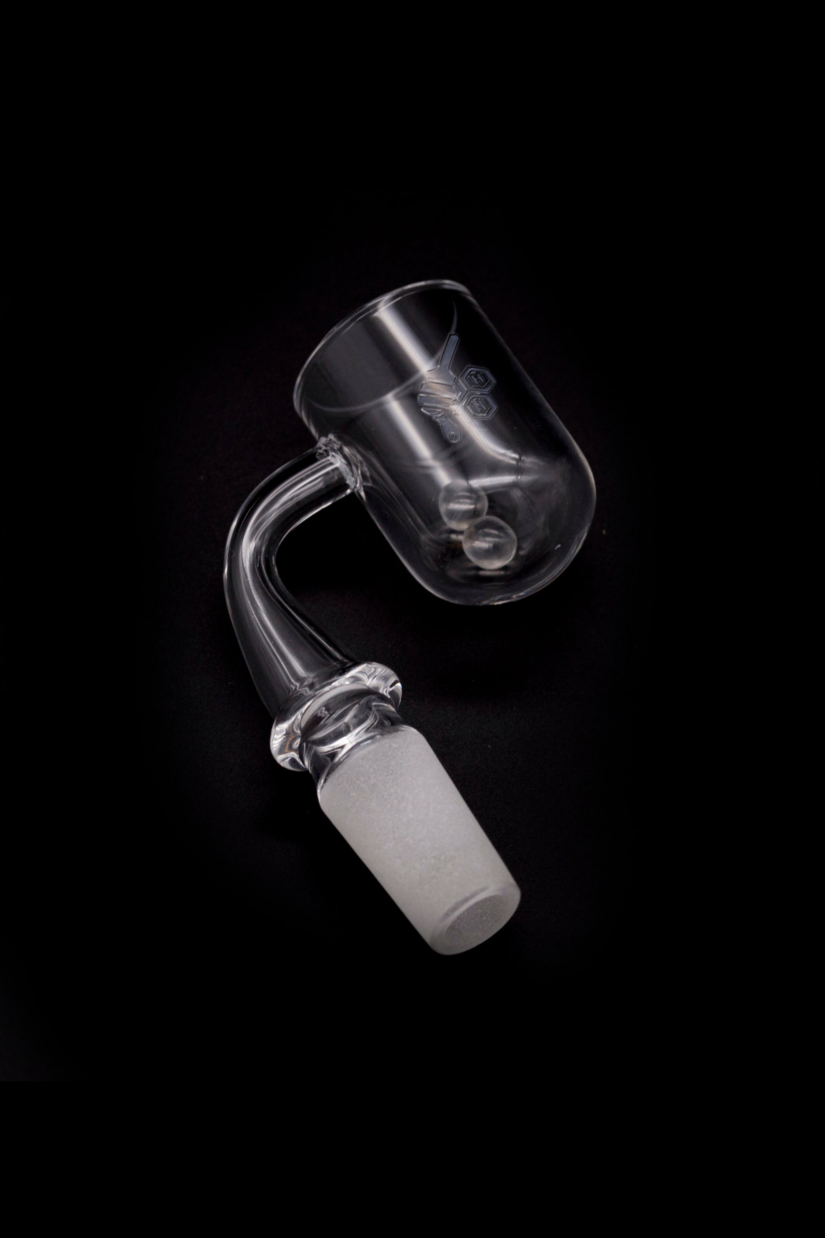 Clear quartz dab rig nail with a visible ceramic insert, isolated on a black background.