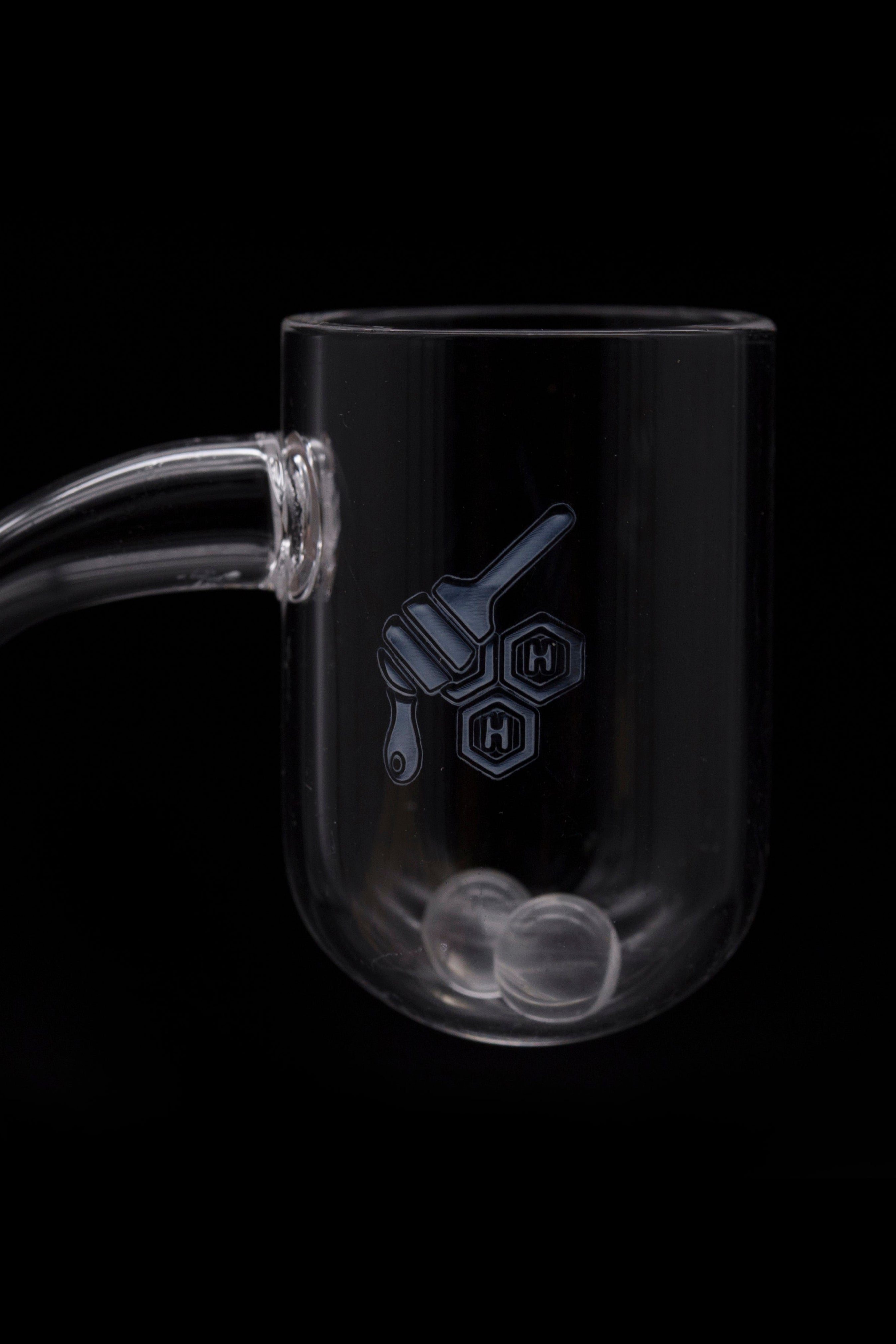 Clear glass rig with a honeycomb and hand logo, isolated on black.