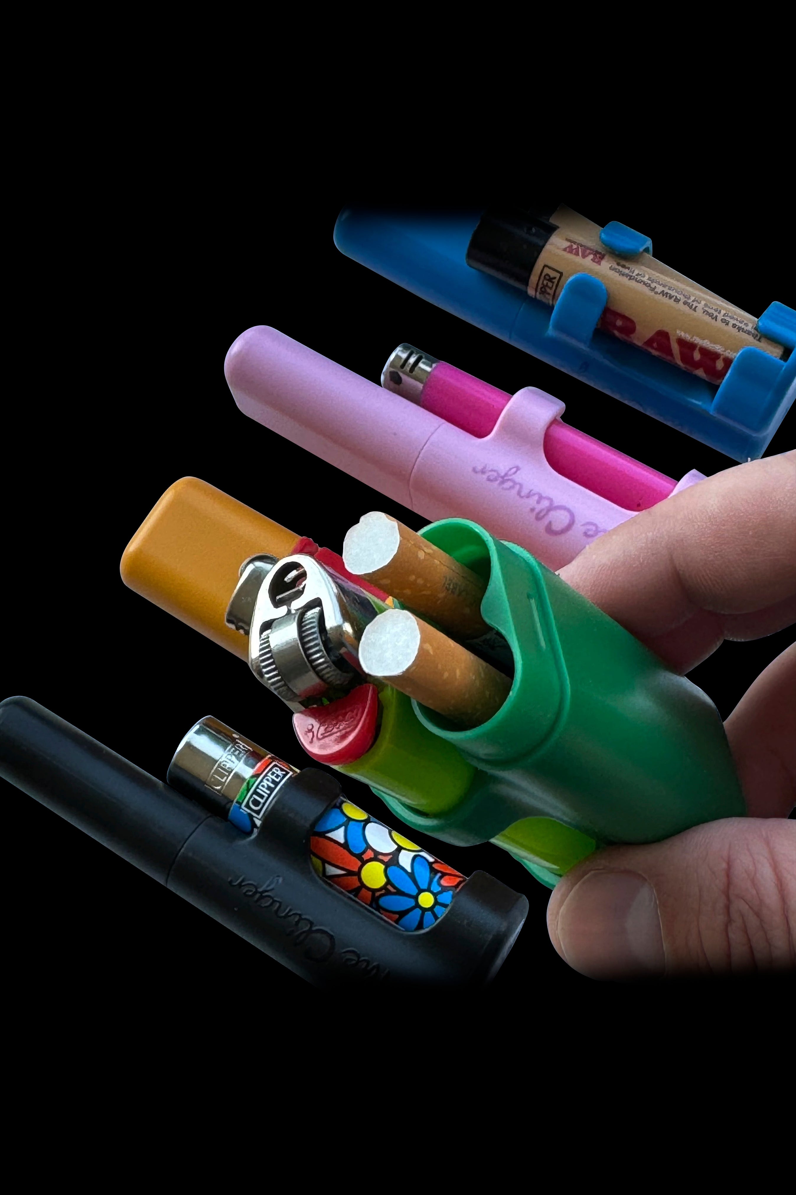 A collection of colorful cannabis accessories, including tubes, a lighter, and a grinder, stacked against a dark background.