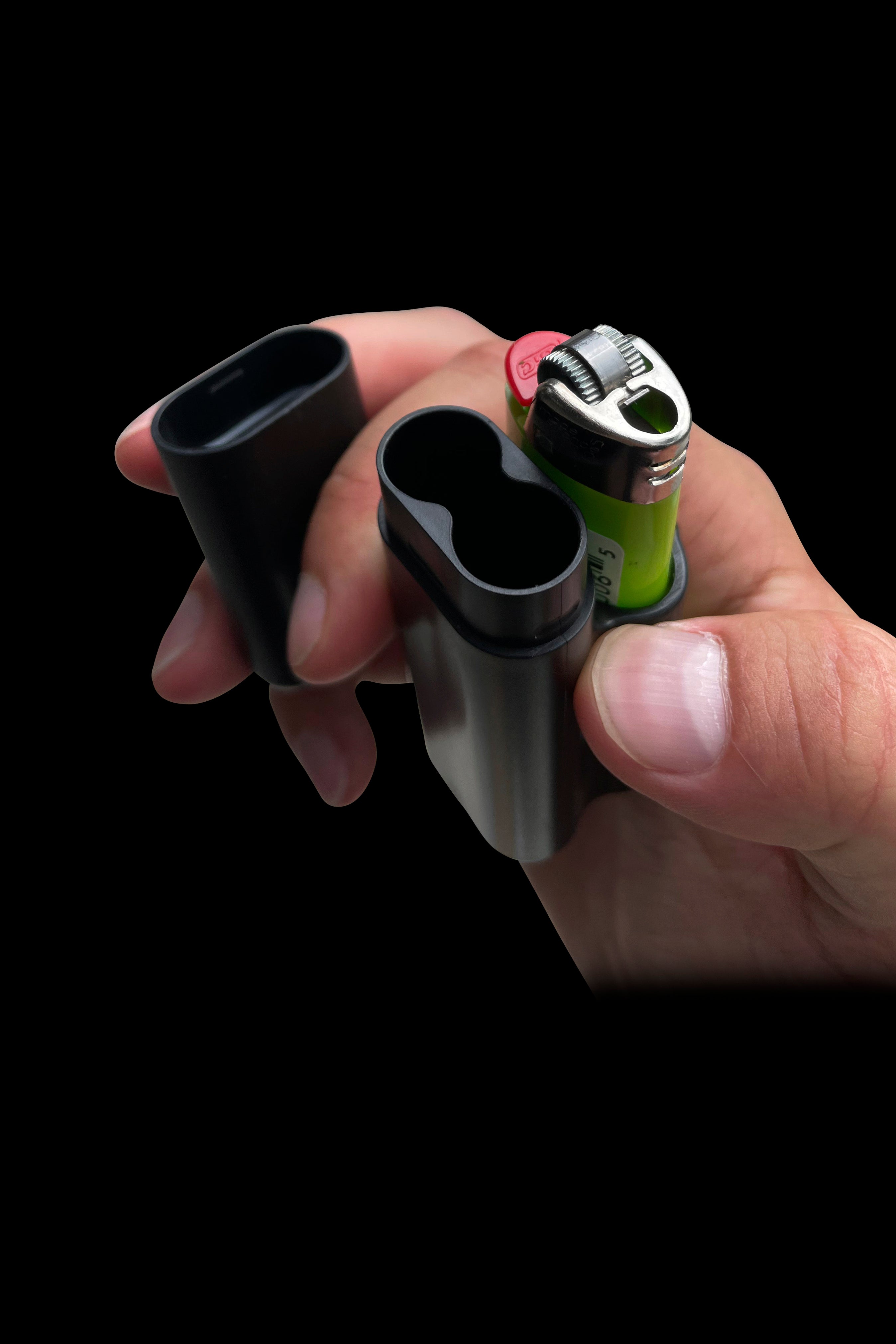 Hand holding a glass pipe and lighter against a black background.