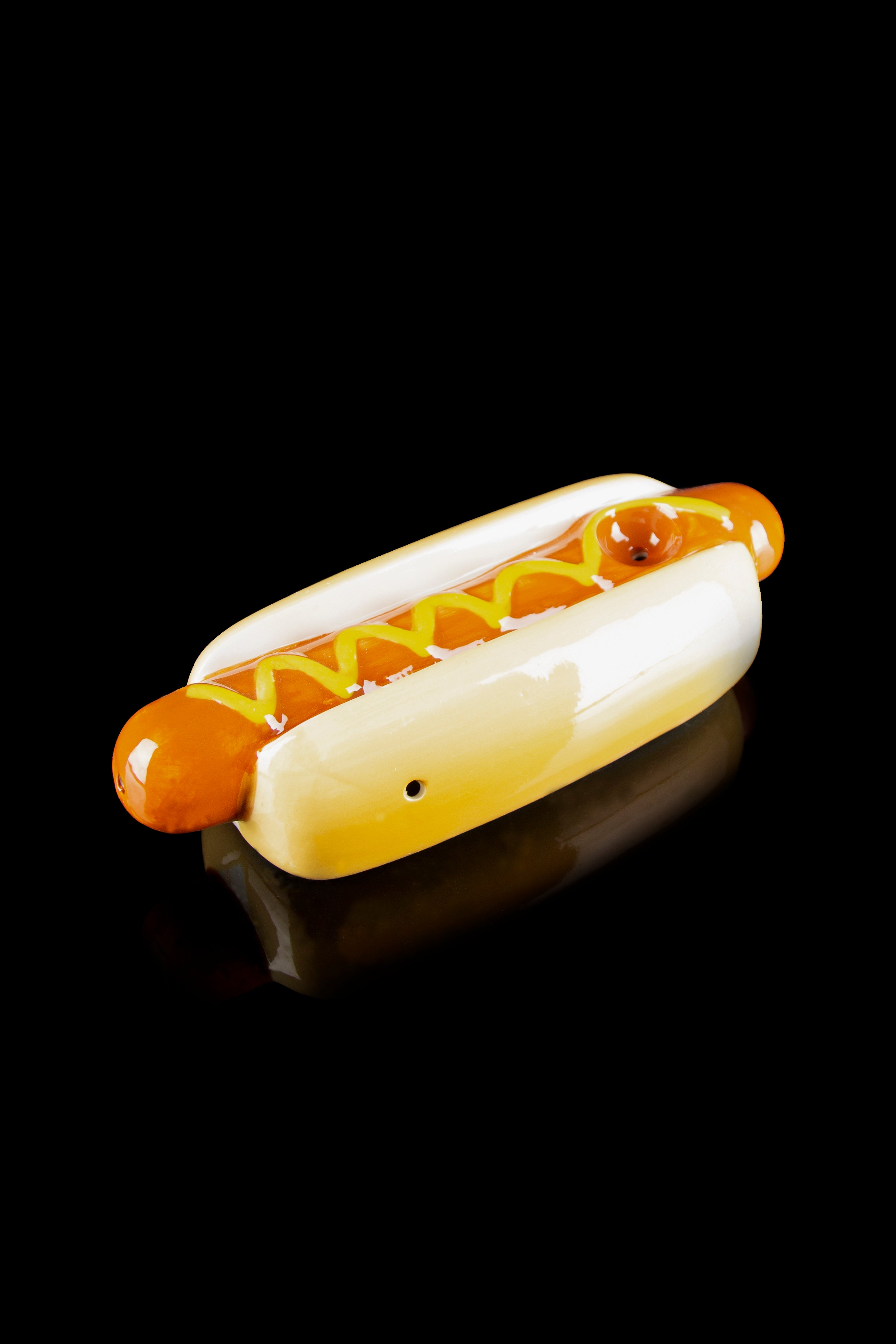 Glass hot dog-shaped pipe with orange and yellow accents, resembling a fully loaded hot dog.
