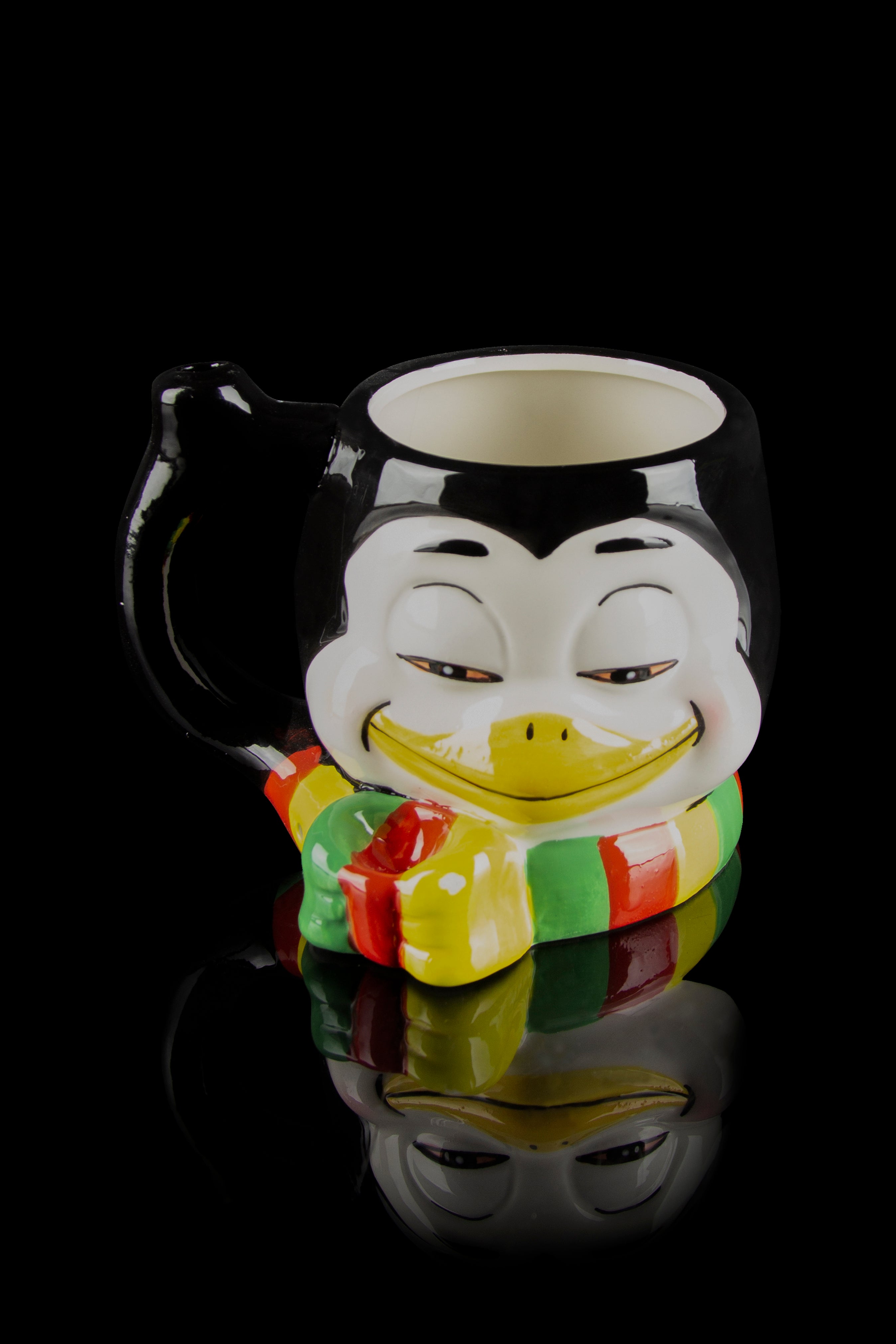 Ceramic water pipe shaped like a smiling, traditionally dressed Japanese man, reflected on a black surface.