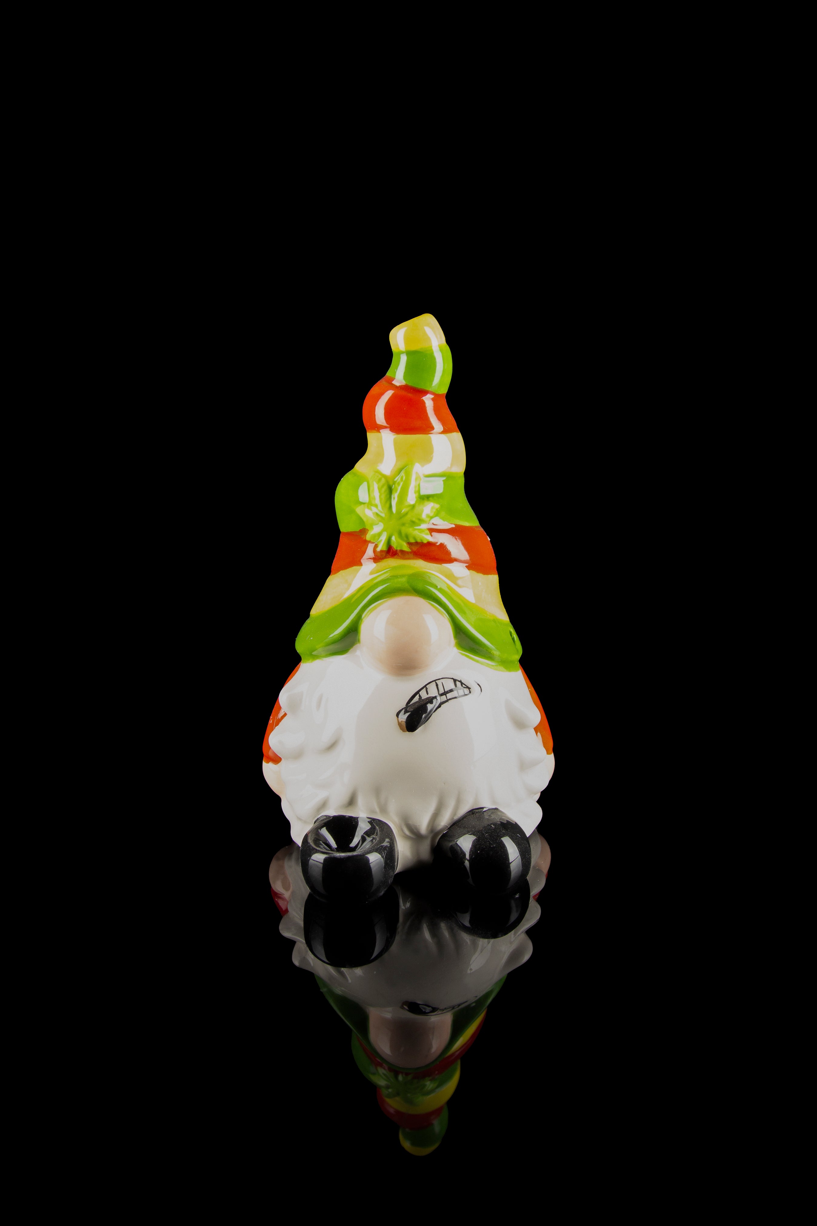 A colorful glass sculpture of a garden gnome wearing sunglasses, with cannabis leaf details, against a black background.