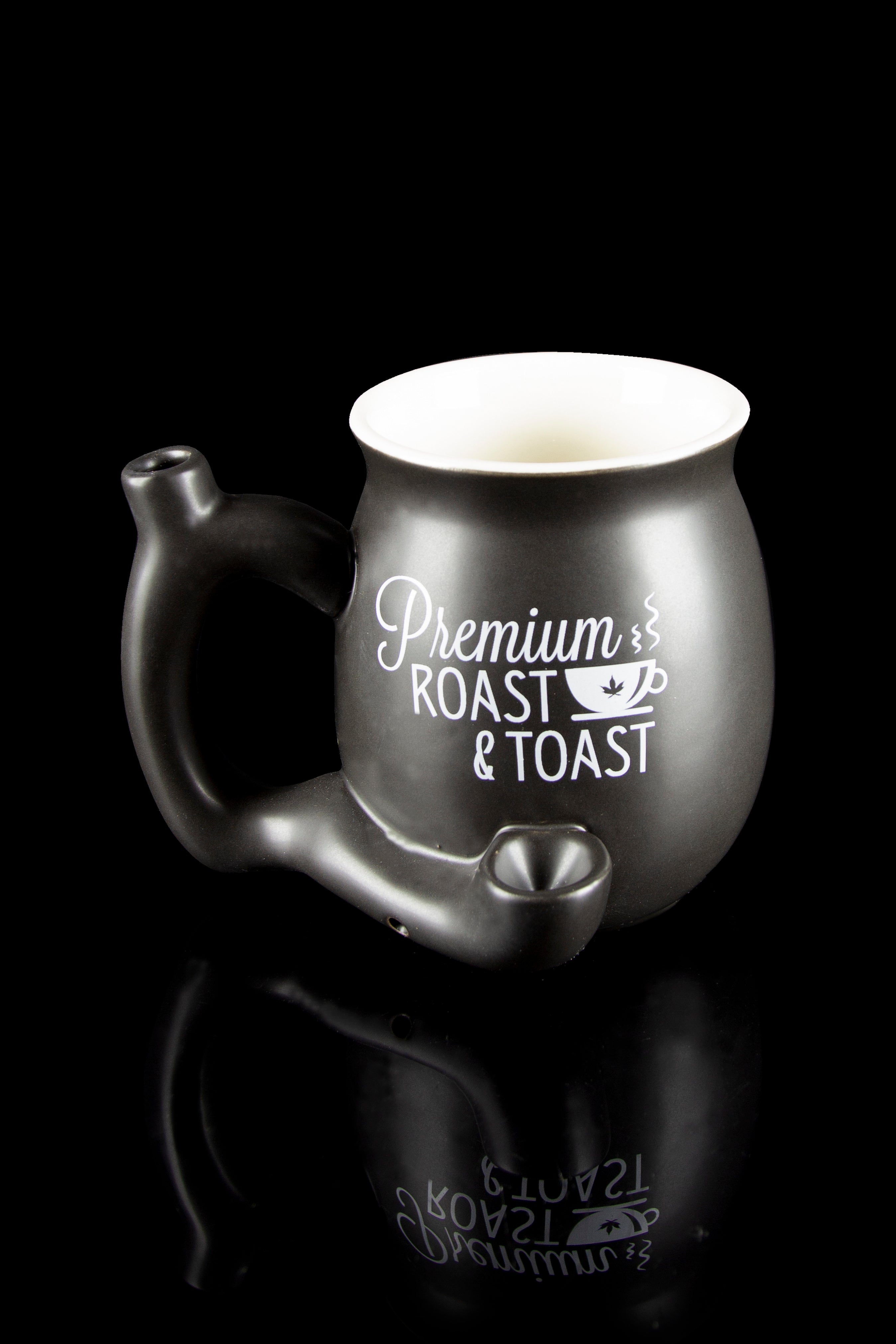 Black ceramic cannabis water pipe shaped like a teapot with “Premium Roast & Toast” script, reflecting on a dark surface.