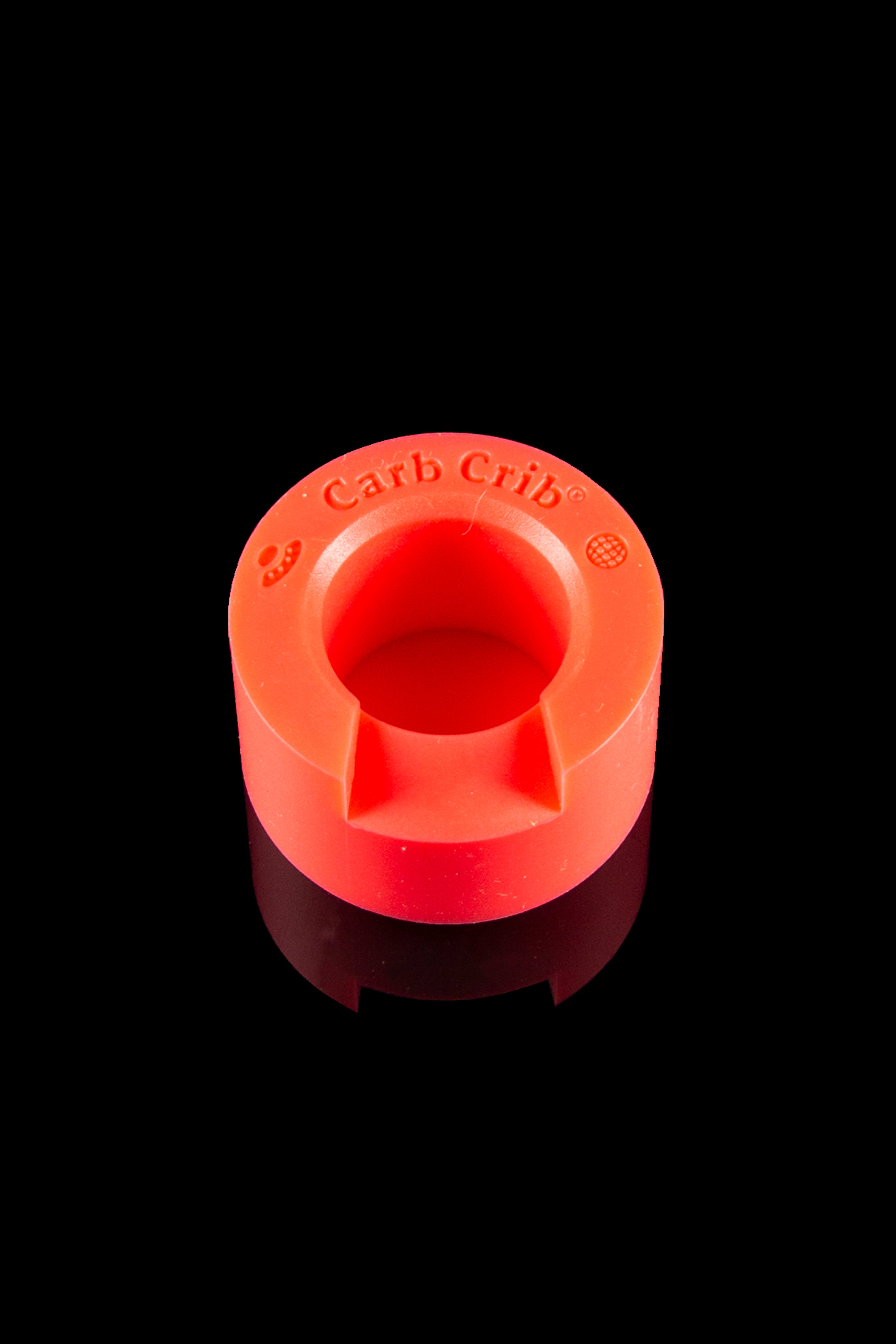 Red silicone carb cap with “Carb Crib” text, isolated on a black background.