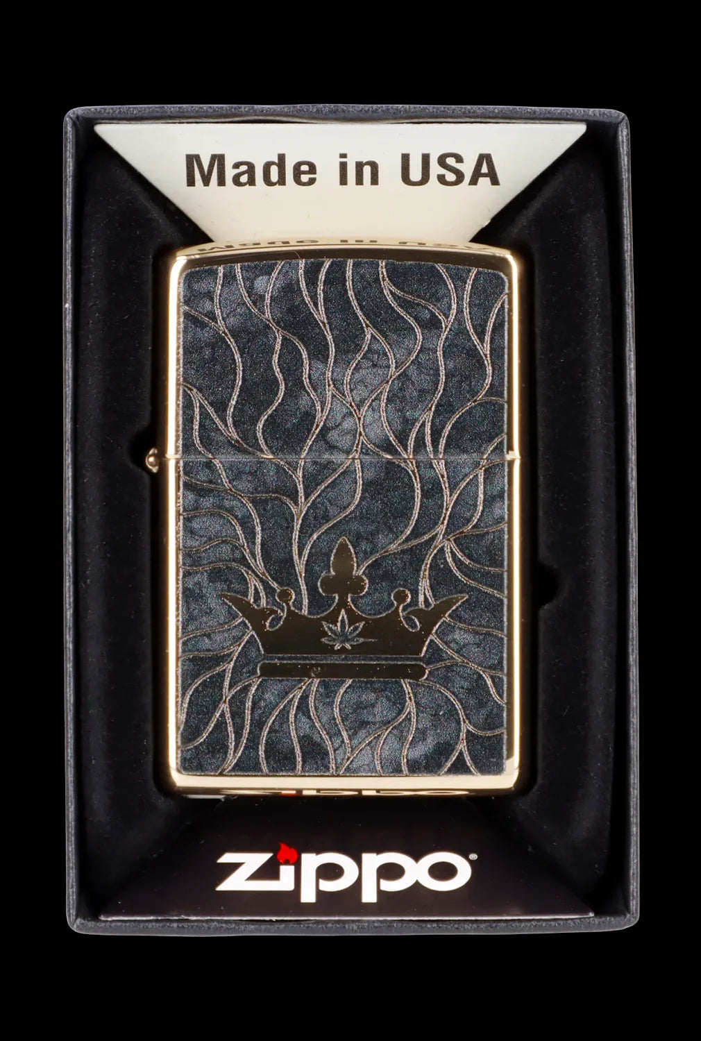 Zippo lighter with engraved cannabis leaf and vine design in a black display box.