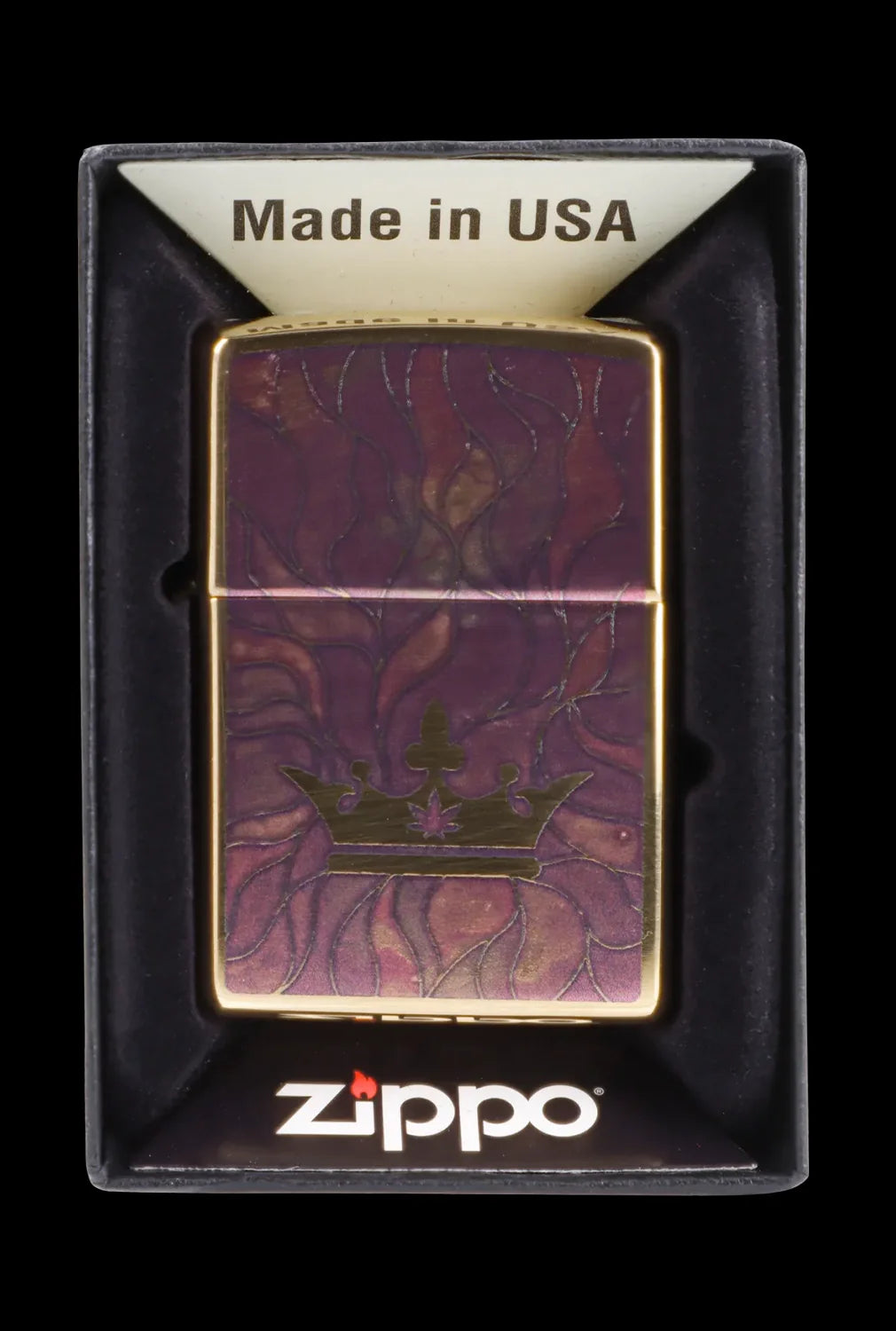 Zippo lighter with a burgundy and gold cannabis leaf design, displayed in a black box.