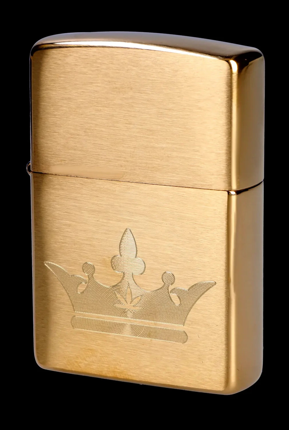 Gold Zippo lighter with a cannabis leaf design engraved on the front.