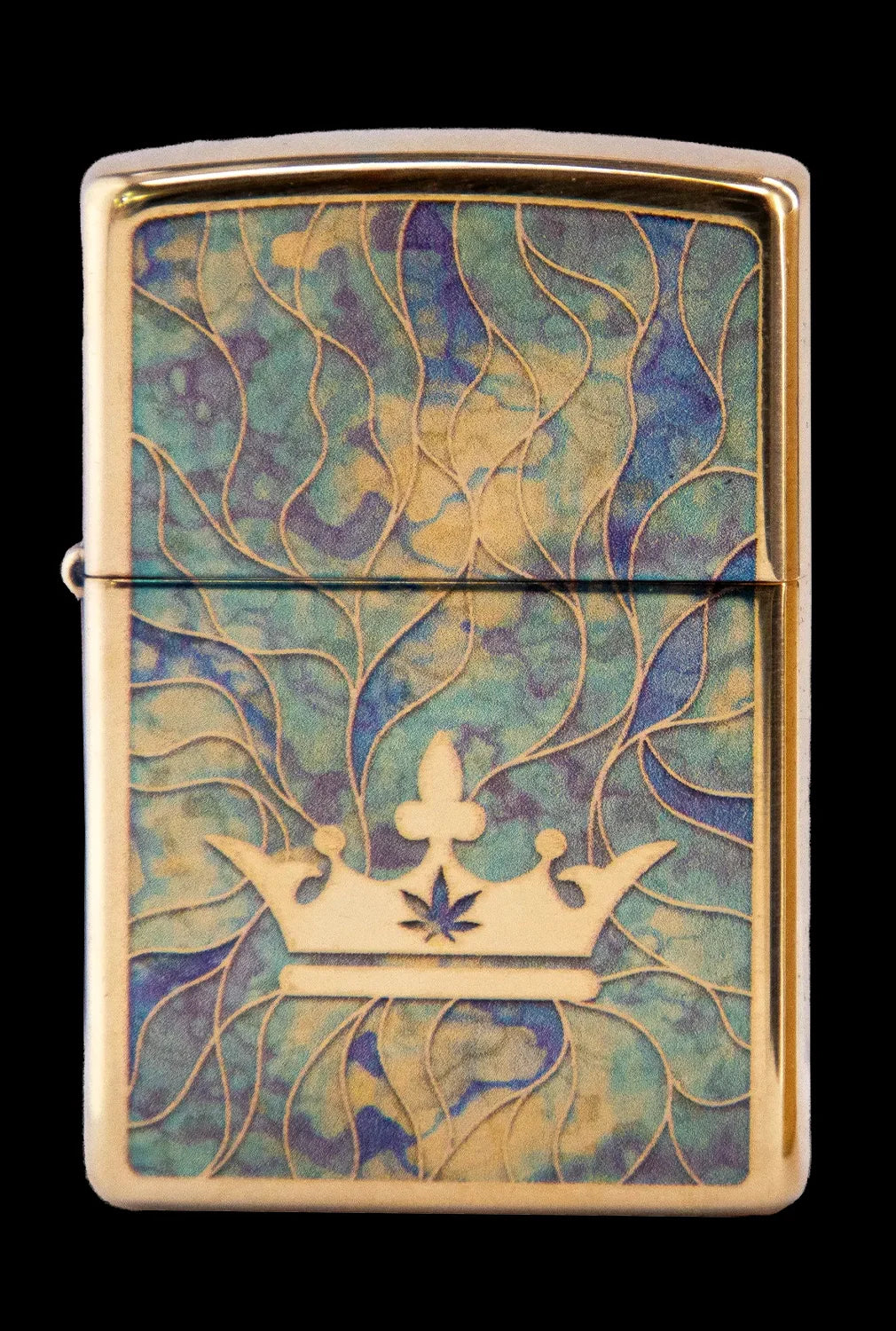 Gold Zippo lighter with a raised cannabis leaf within a golden crown design on a swirling teal and gold background.