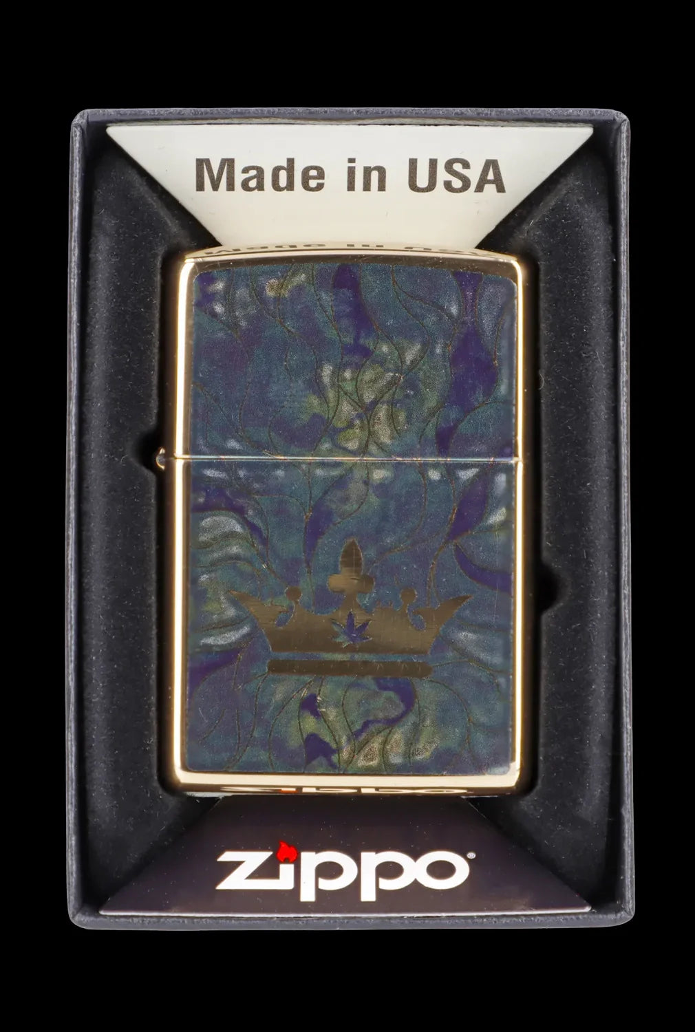 Zippo lighter with a cannabis leaf and forest design in a presentation box.