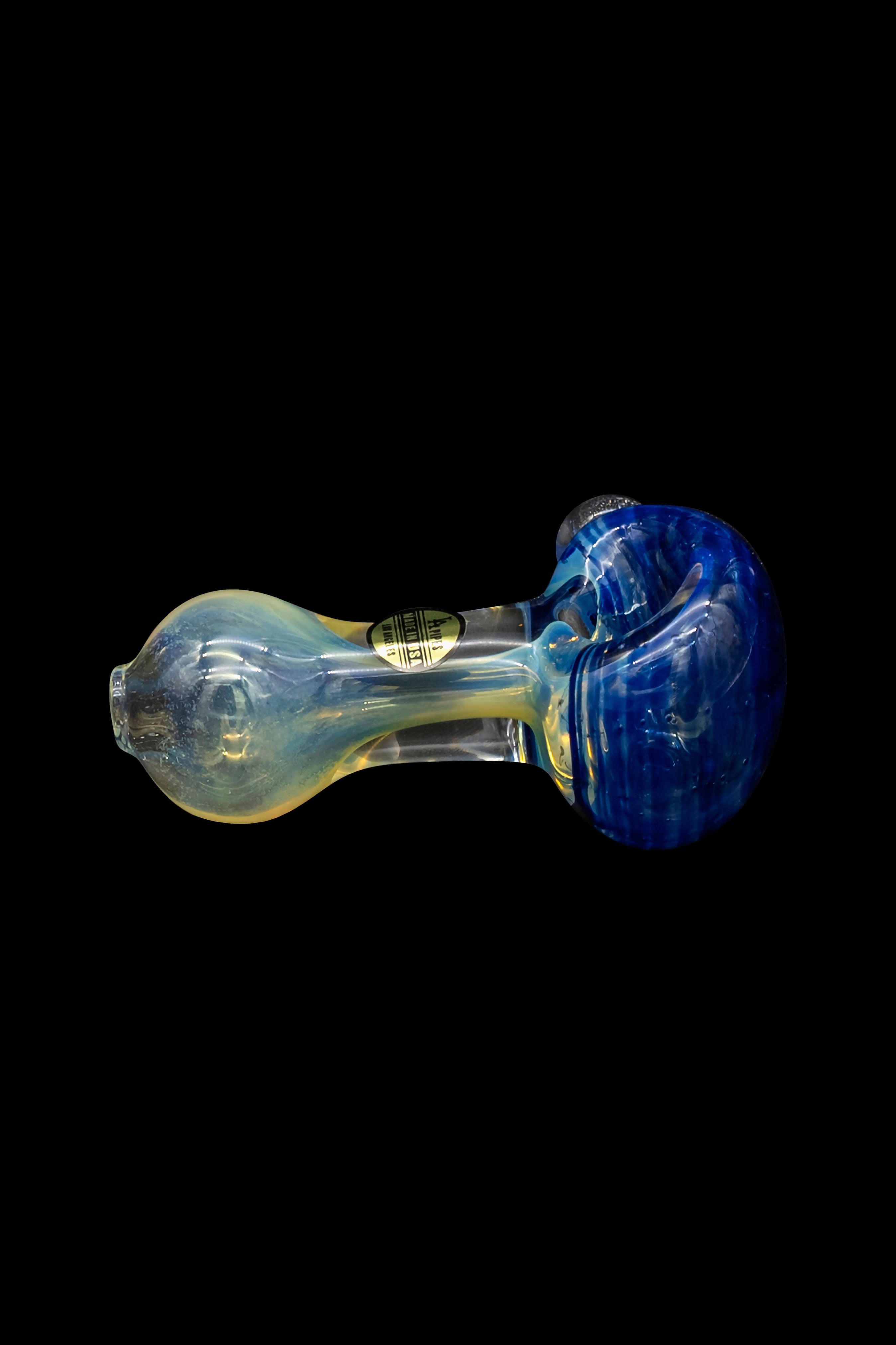 Hand-blown glass pipe with blue and yellow swirls against a black background.