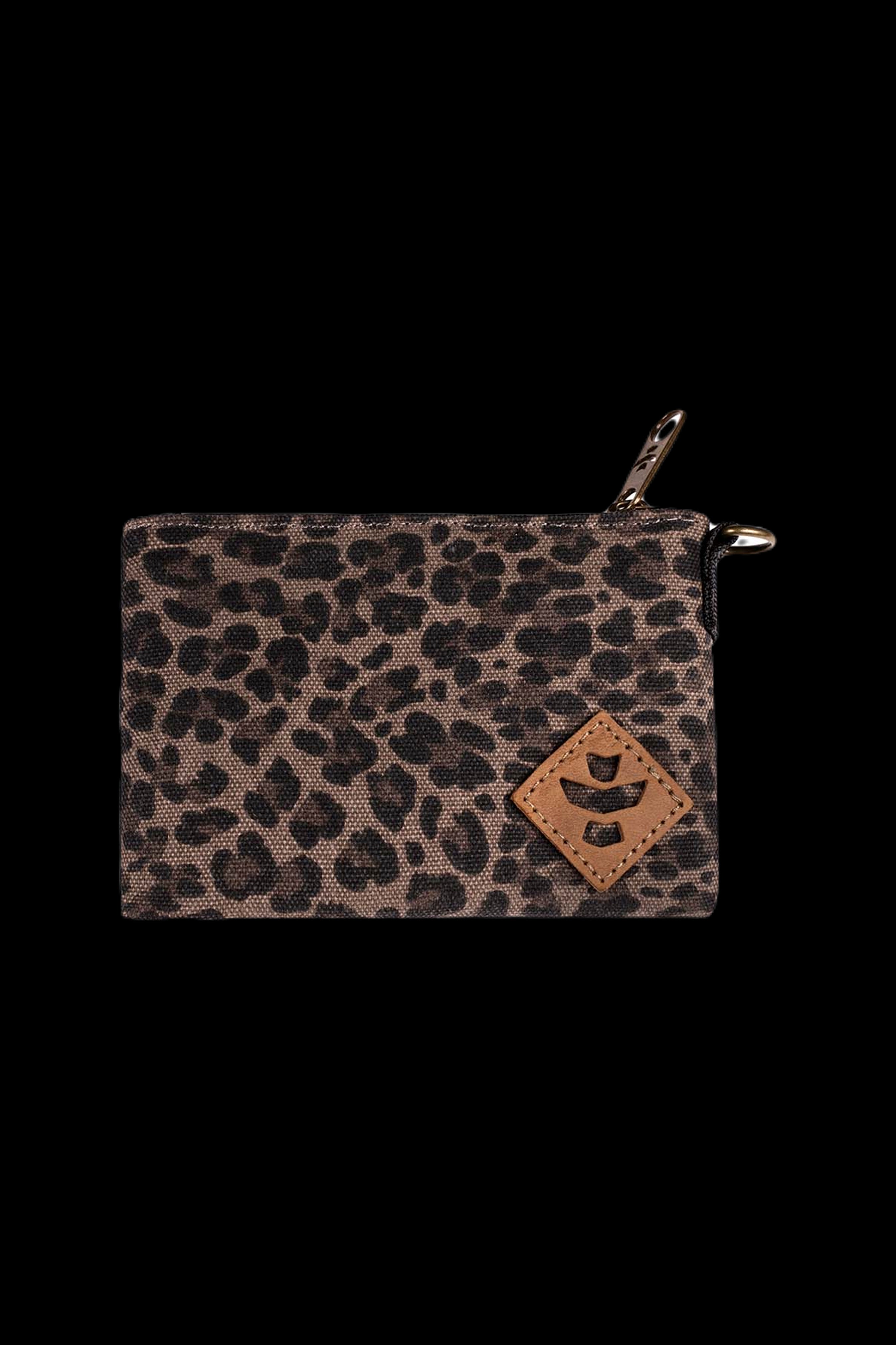 Close-up front view of the Revelry Supply Smell Proof Zippered Small Stash Bag - The Mini Broker showing a leopard-print fabric, leather diamond patch, and top zipper against a black background.