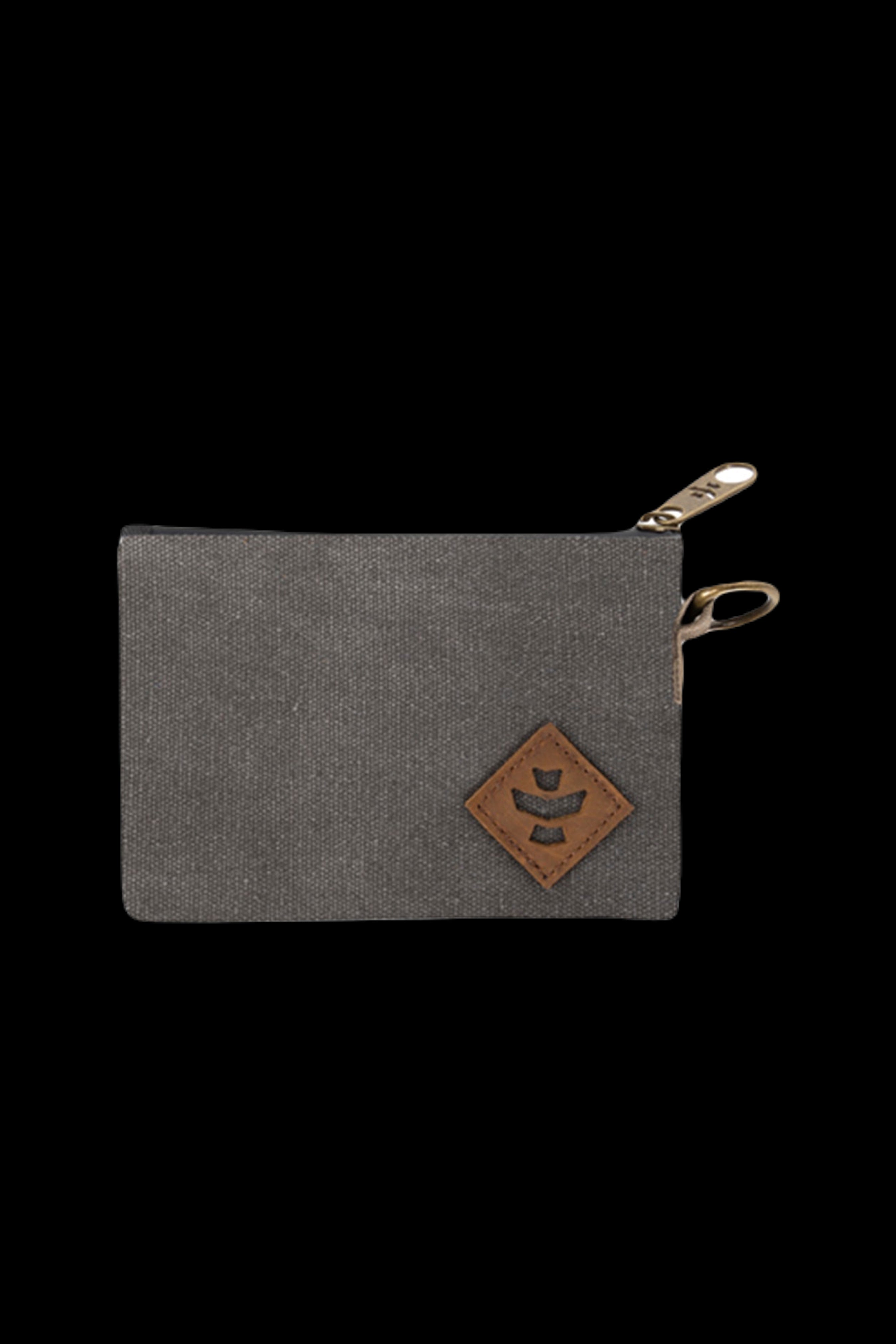 Top-down close-up of a gray fabric pouch with a leather diamond patch and brass zipper pull, Revelry Supply Smell Proof Zippered Small Stash Bag - The Mini Broker