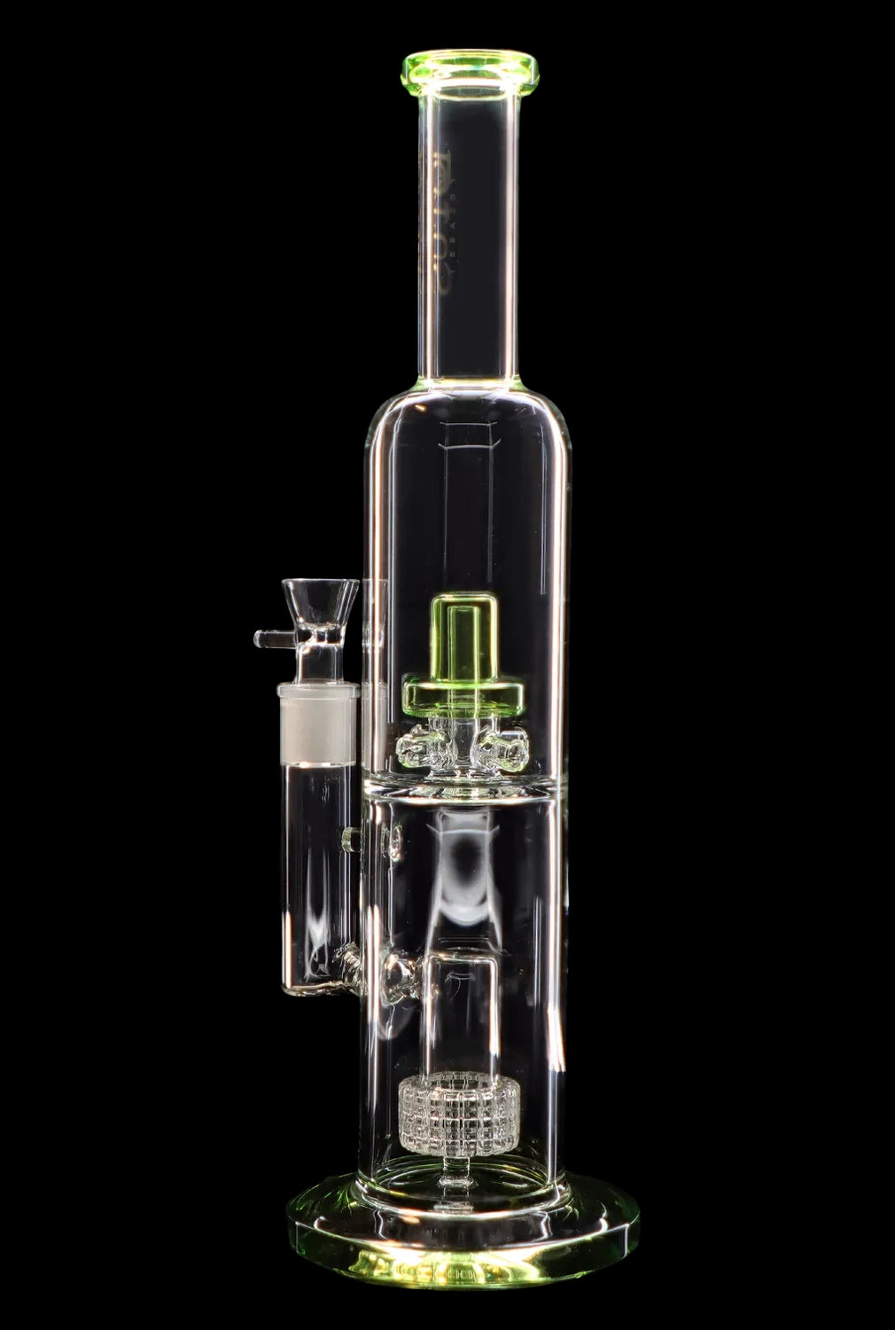 A clear glass water pipe (bong) with green accents and a complex percolator system, isolated on a black background.