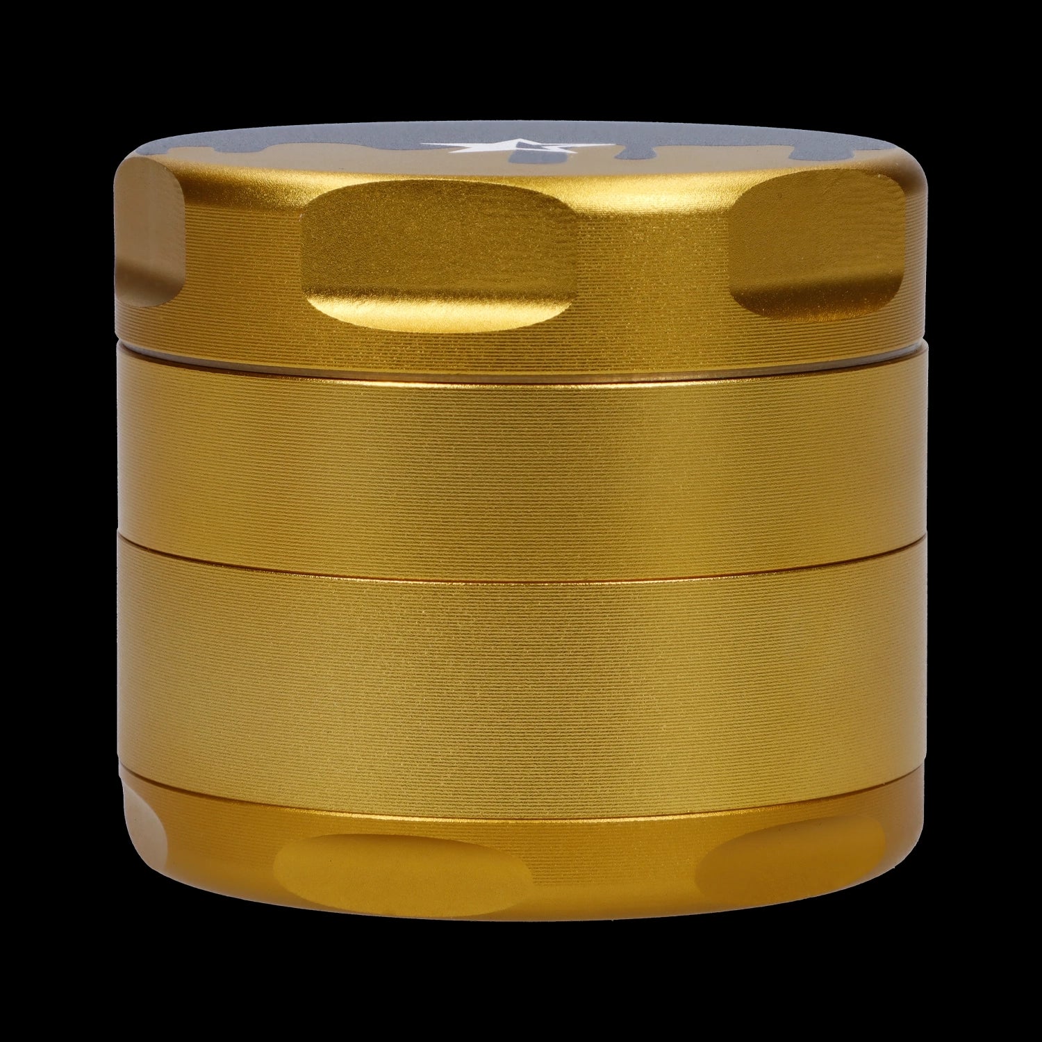 Close-up front view of the gold Famous Design-Surrender Aluminum 3 Stage Grinder-Gold showing its textured stacked chambers and rounded lid against a black background