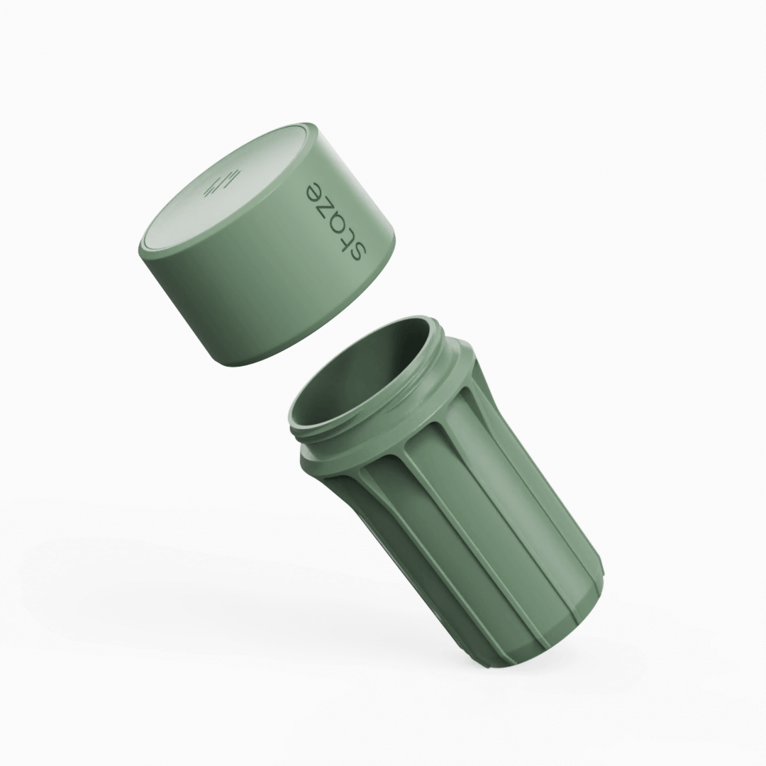 Angled view of the clay-colored STAZE PRESERVE with its cylindrical cap floating above the fluted, open container against a white background