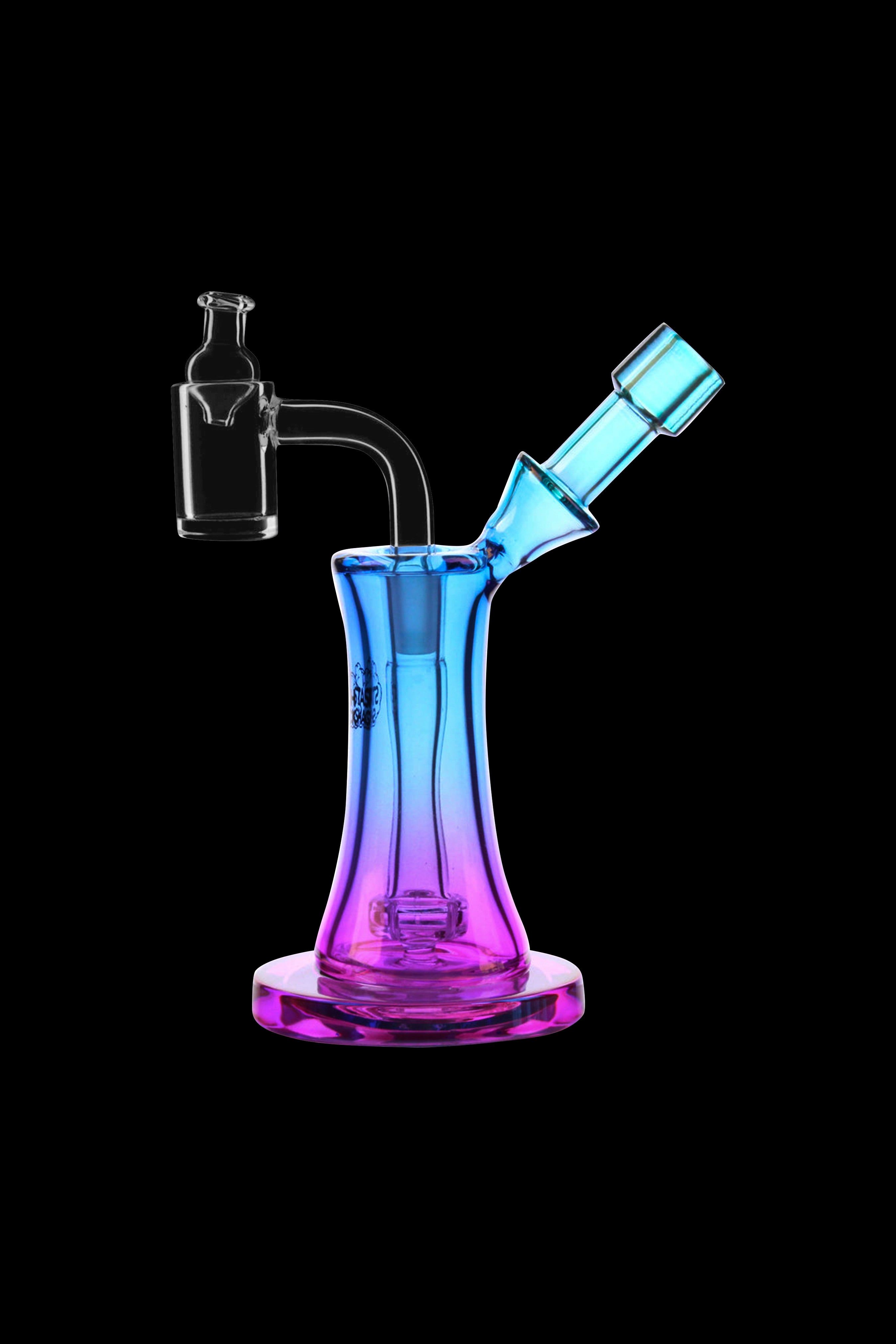 Colorful glass dab rig with quartz insert against a black background.