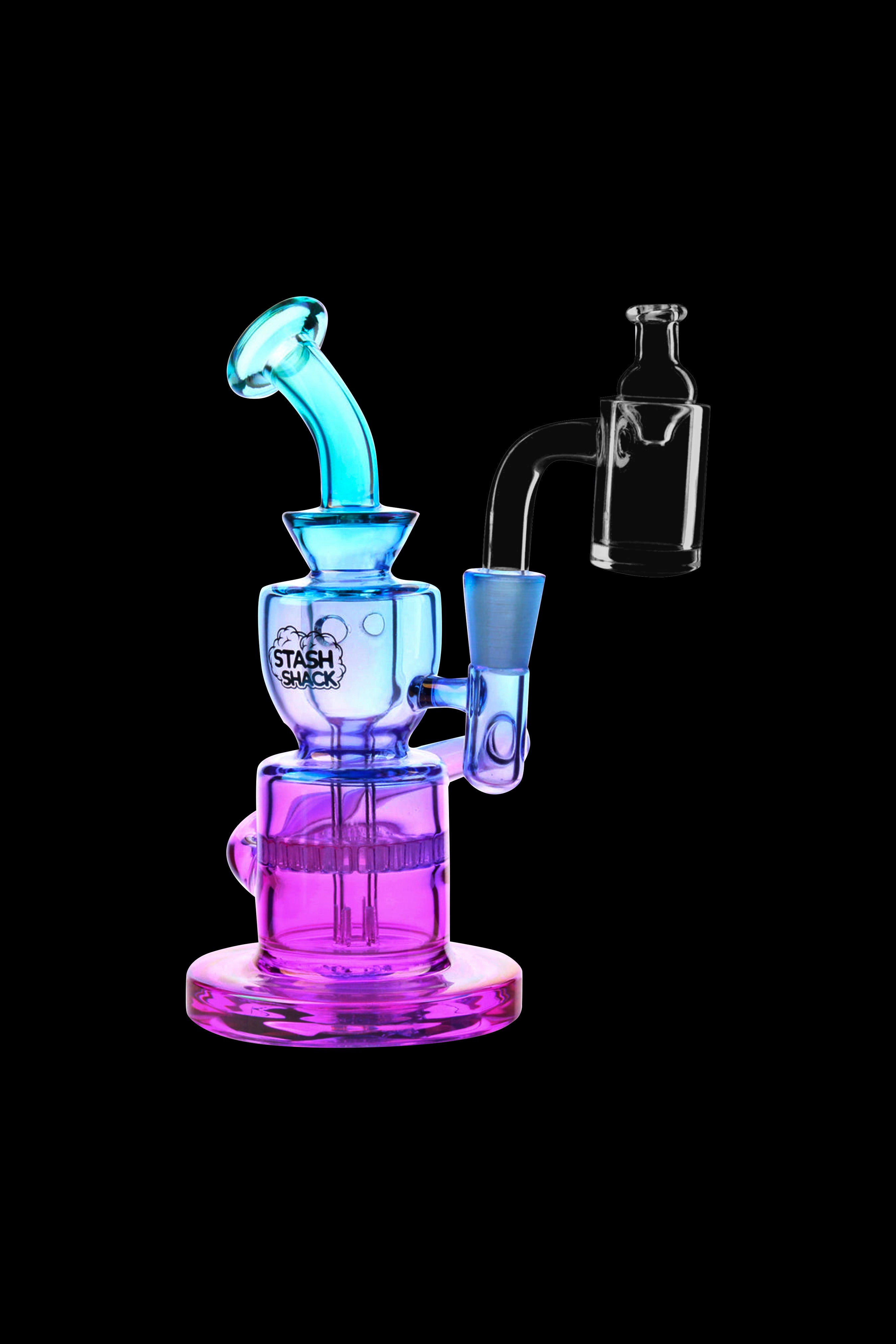Colorful glass water pipe (rig) with a quartz banger, isolated on a black background.