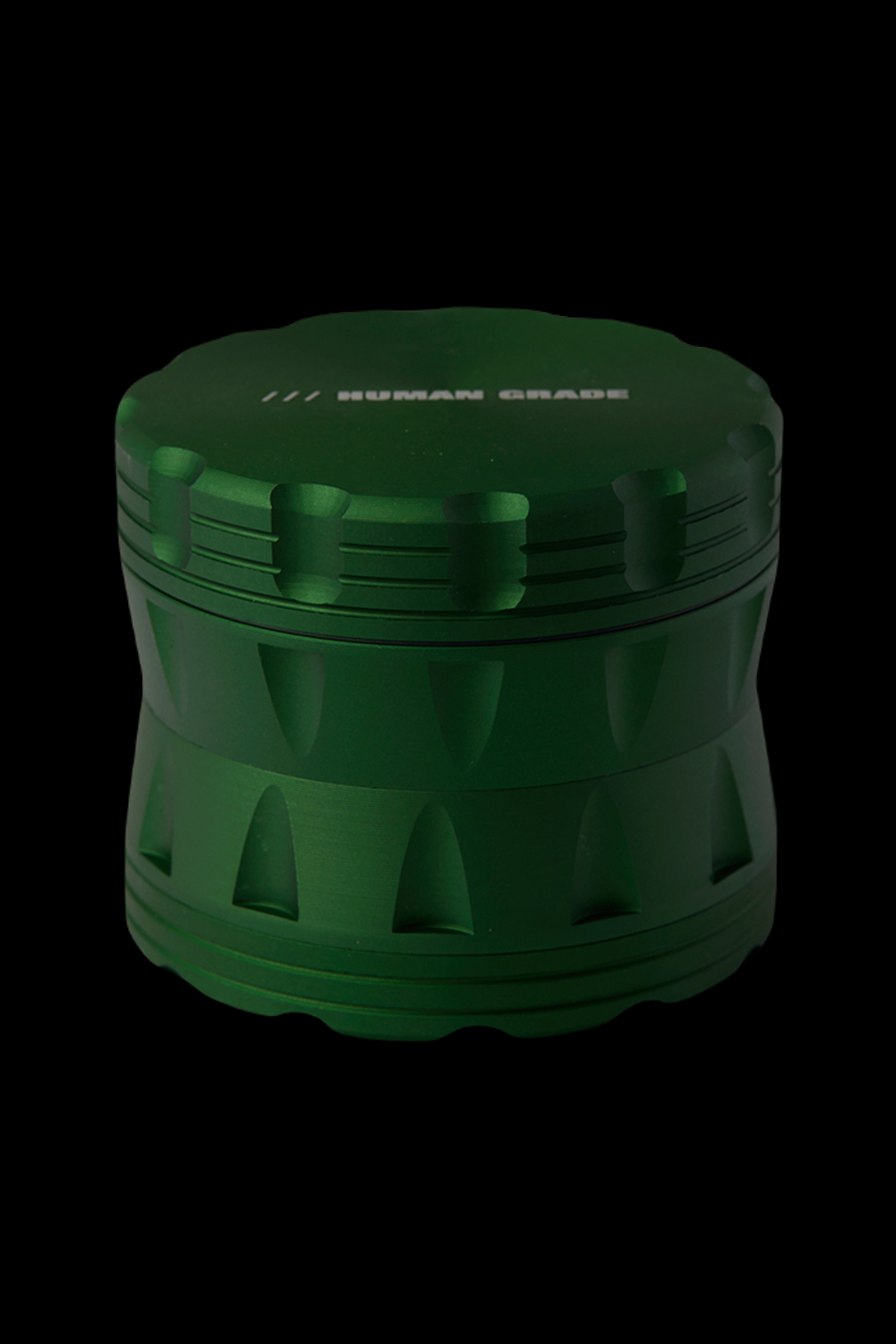 Green four-piece cannabis grinder with textured sides.