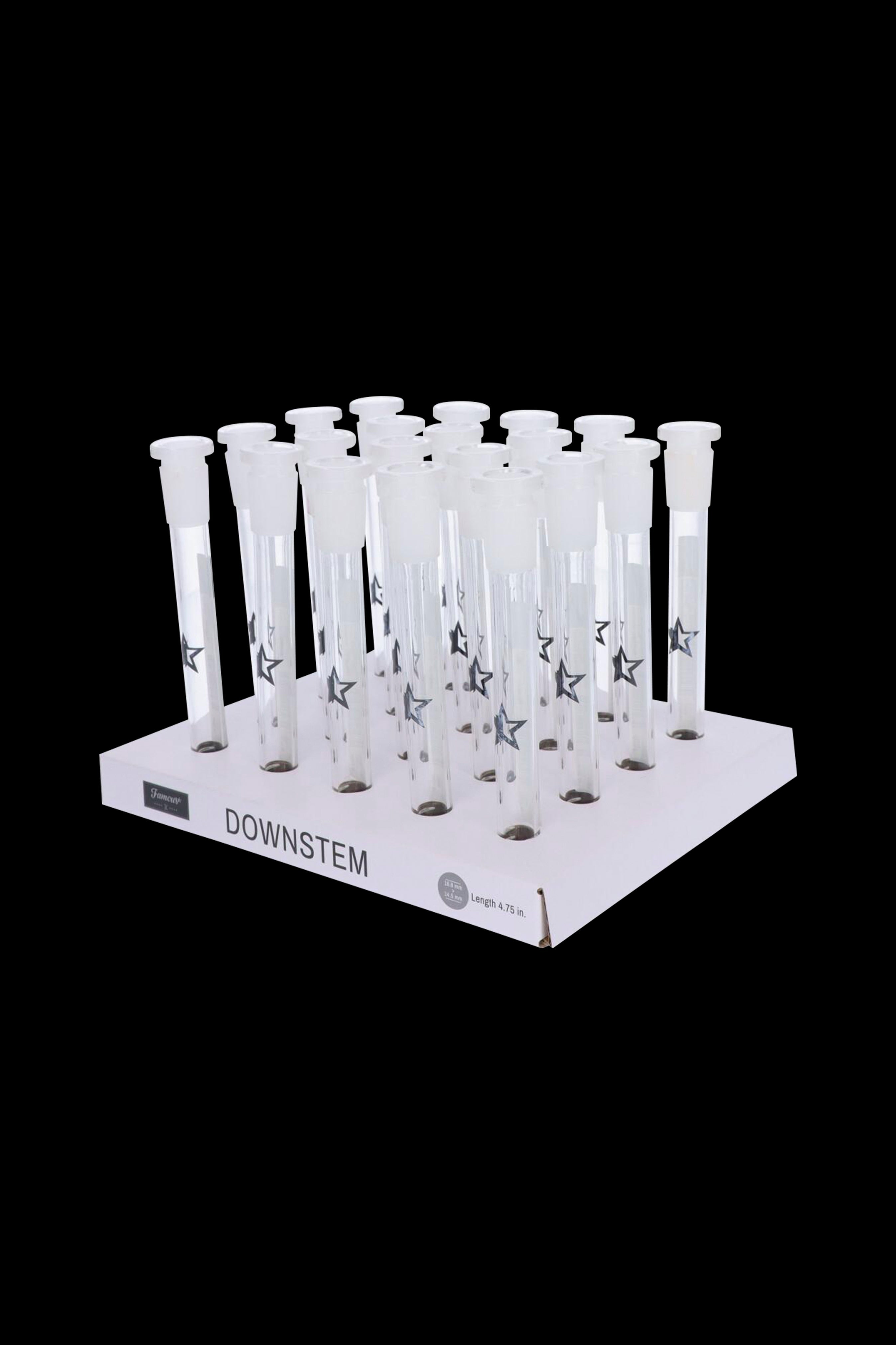 Clear glass downstems with star detailing arranged on a white display stand, labeled "DOWNSTEM."