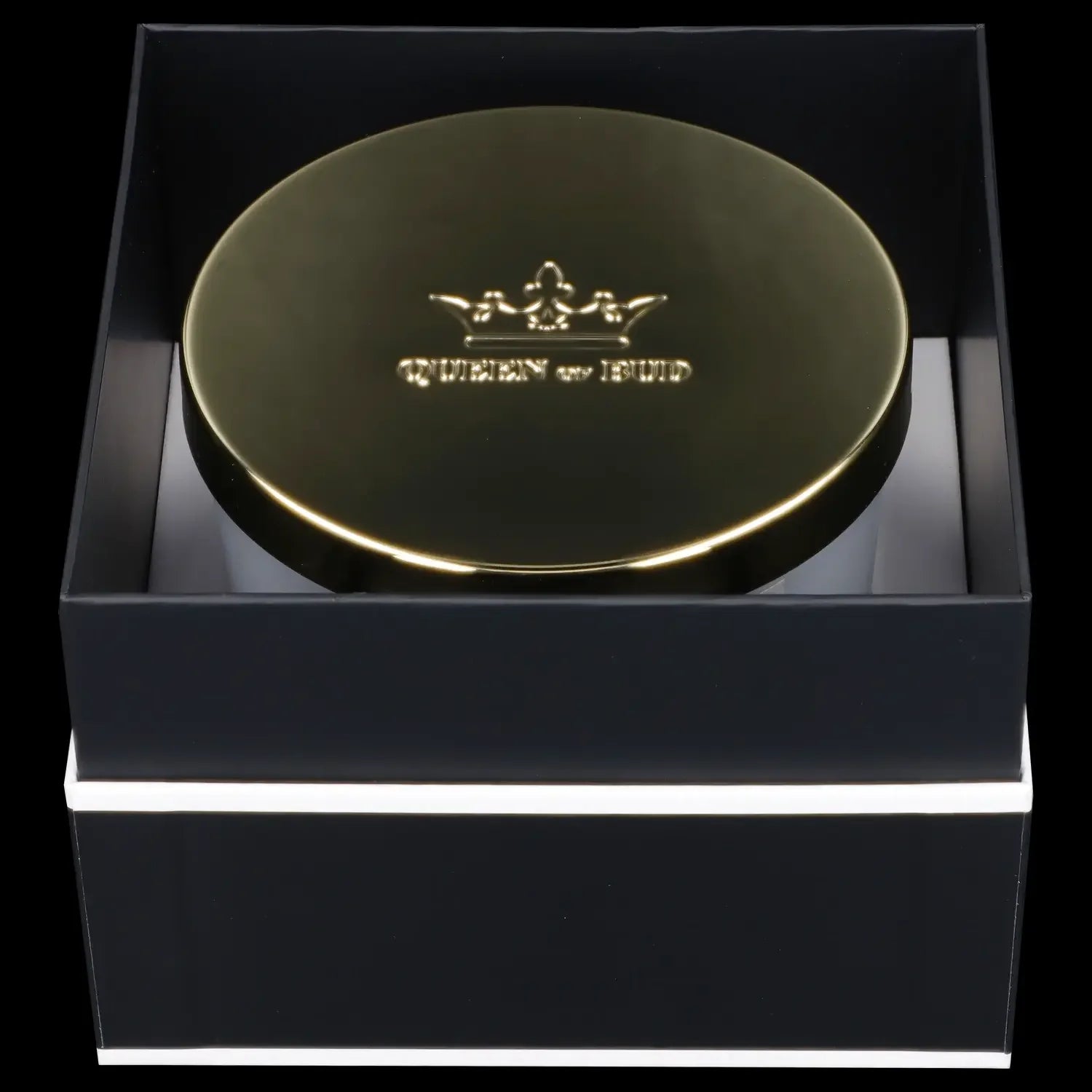 Gold cannabis container presented in a black gift box.