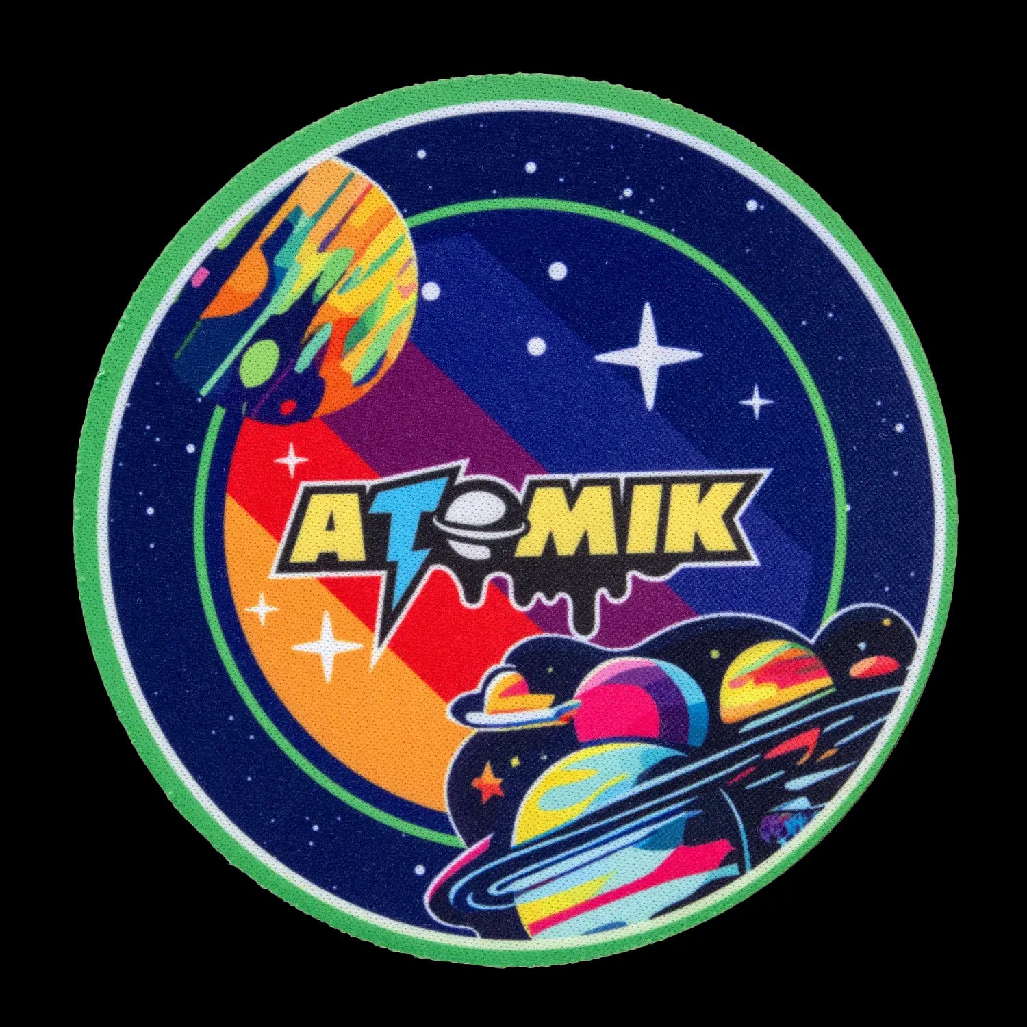 A circular sticker with a vibrant, retro-futuristic space scene featuring the brand name "ATOMIK" in bold lettering, alongside a planet, stars, and a spaceship.