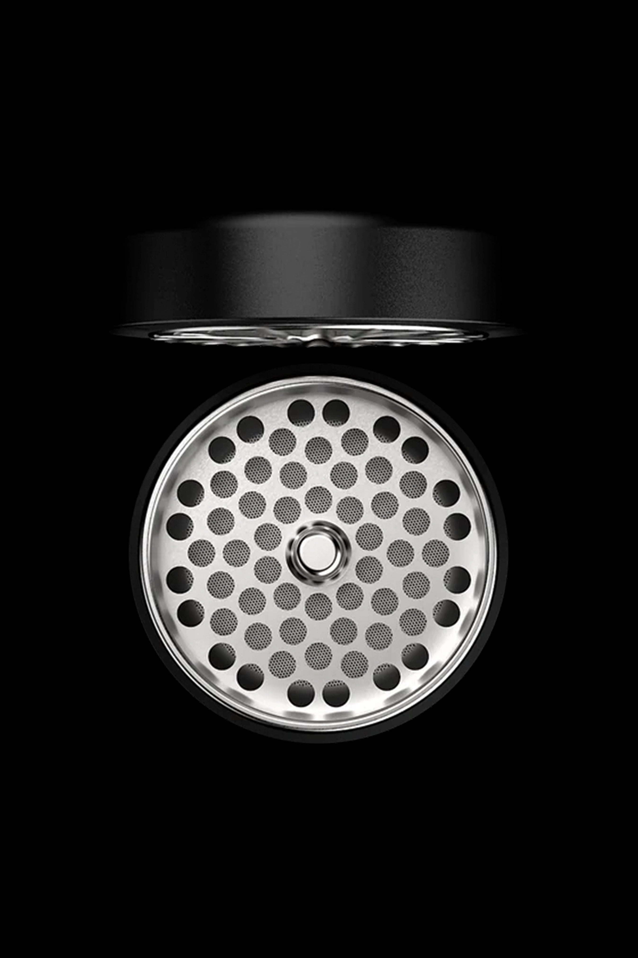 Silver cannabis bowl with perforated pattern against a black background.