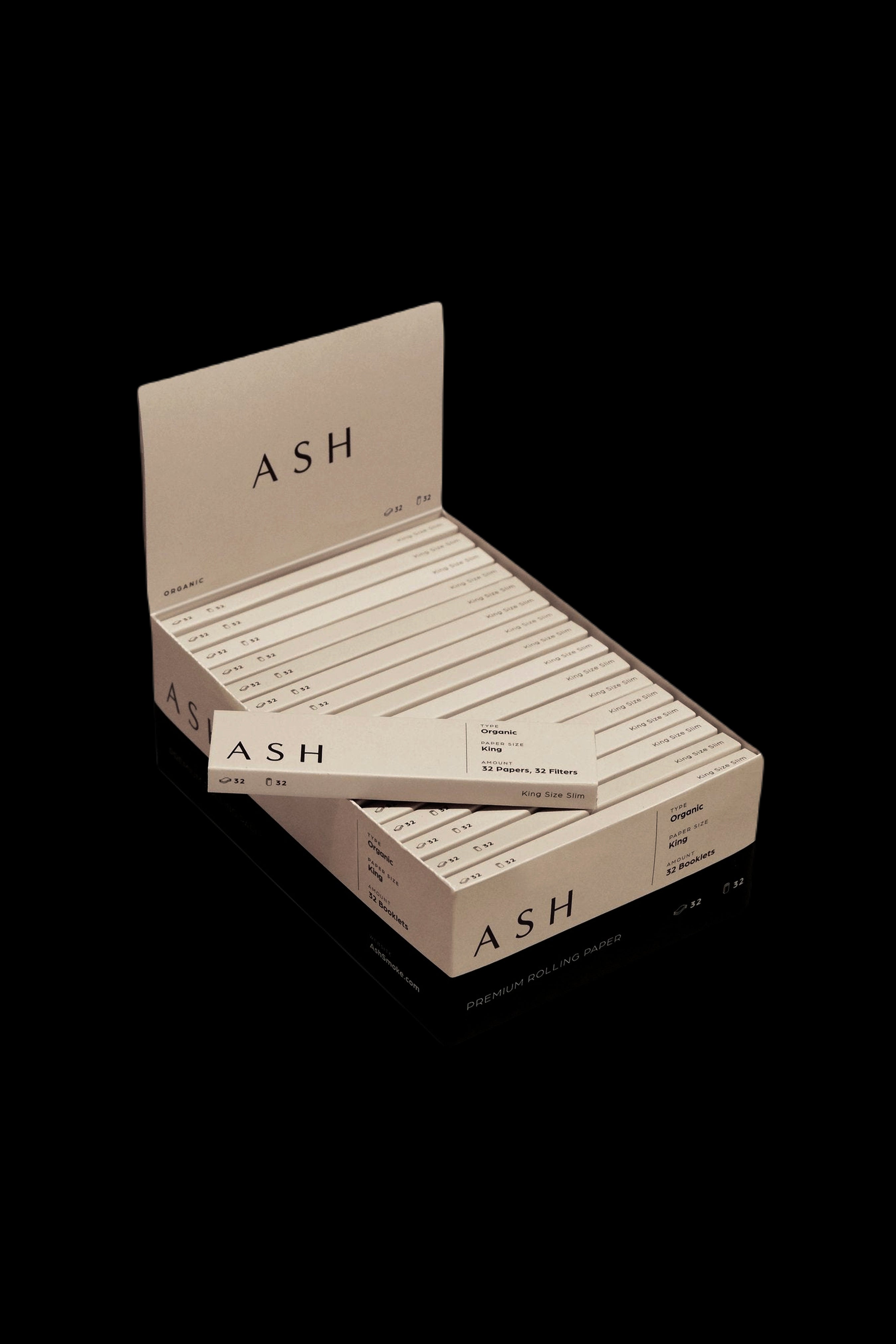 Pack of ASH branded organic rolling papers and filters displayed open on a dark background.