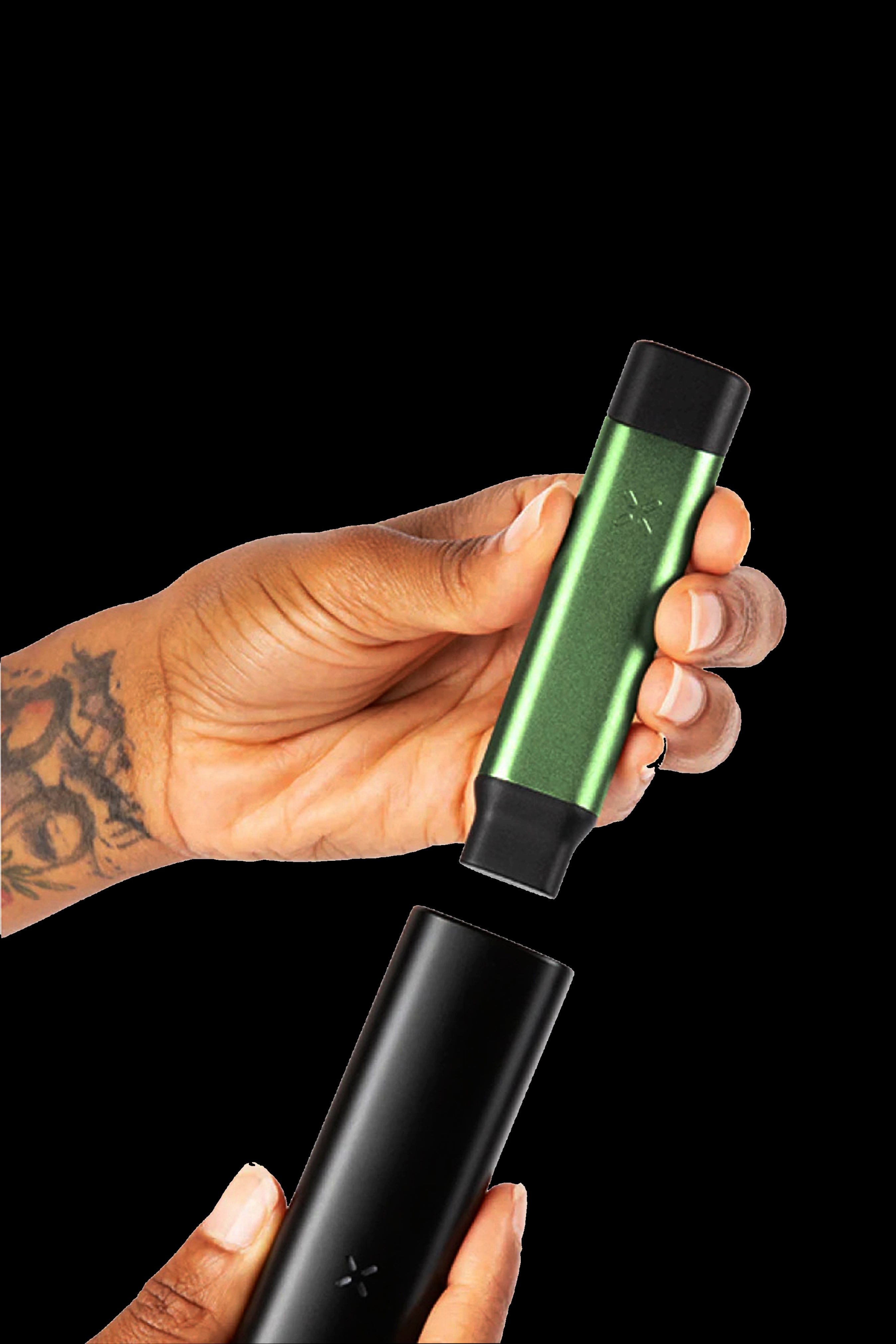 Hand disassembling a green and black Pax vaporizer.