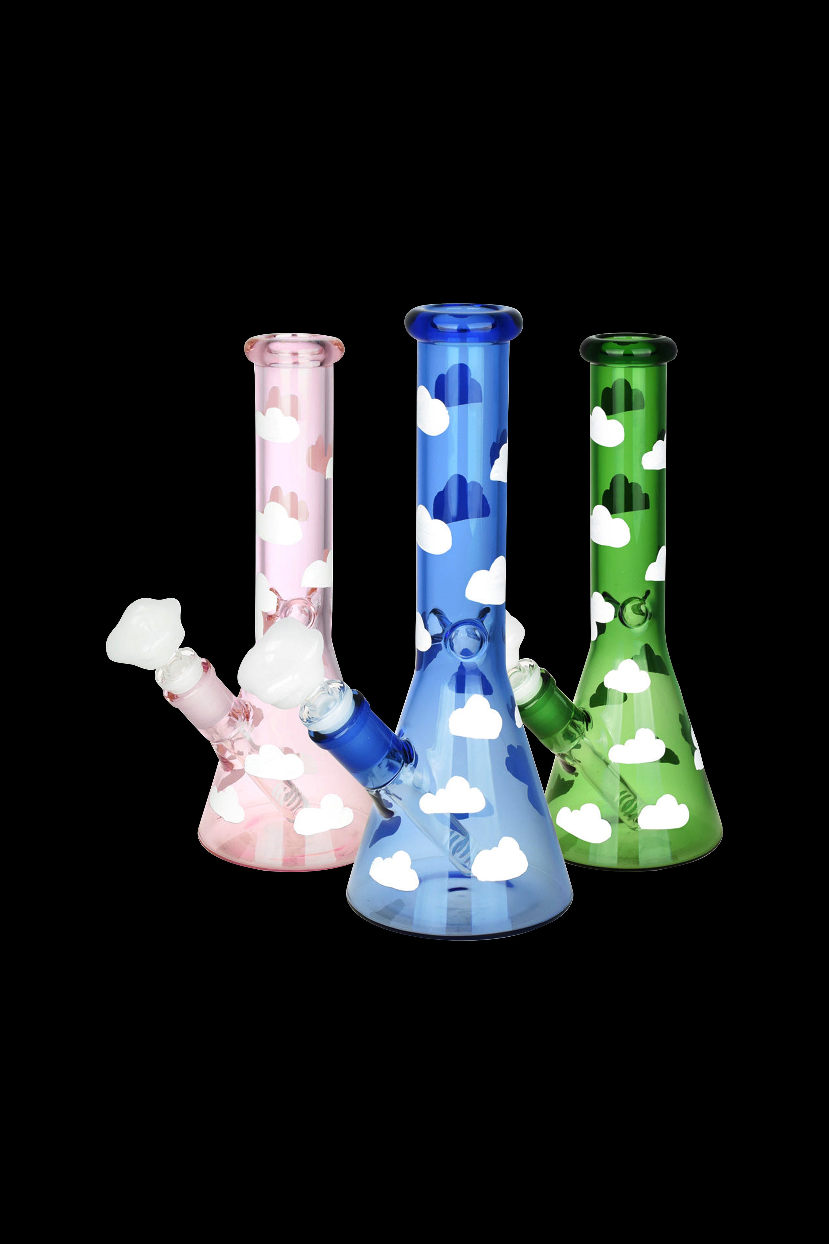 Three glass bongs with cloud patterns in pink, blue, and green against a black background.