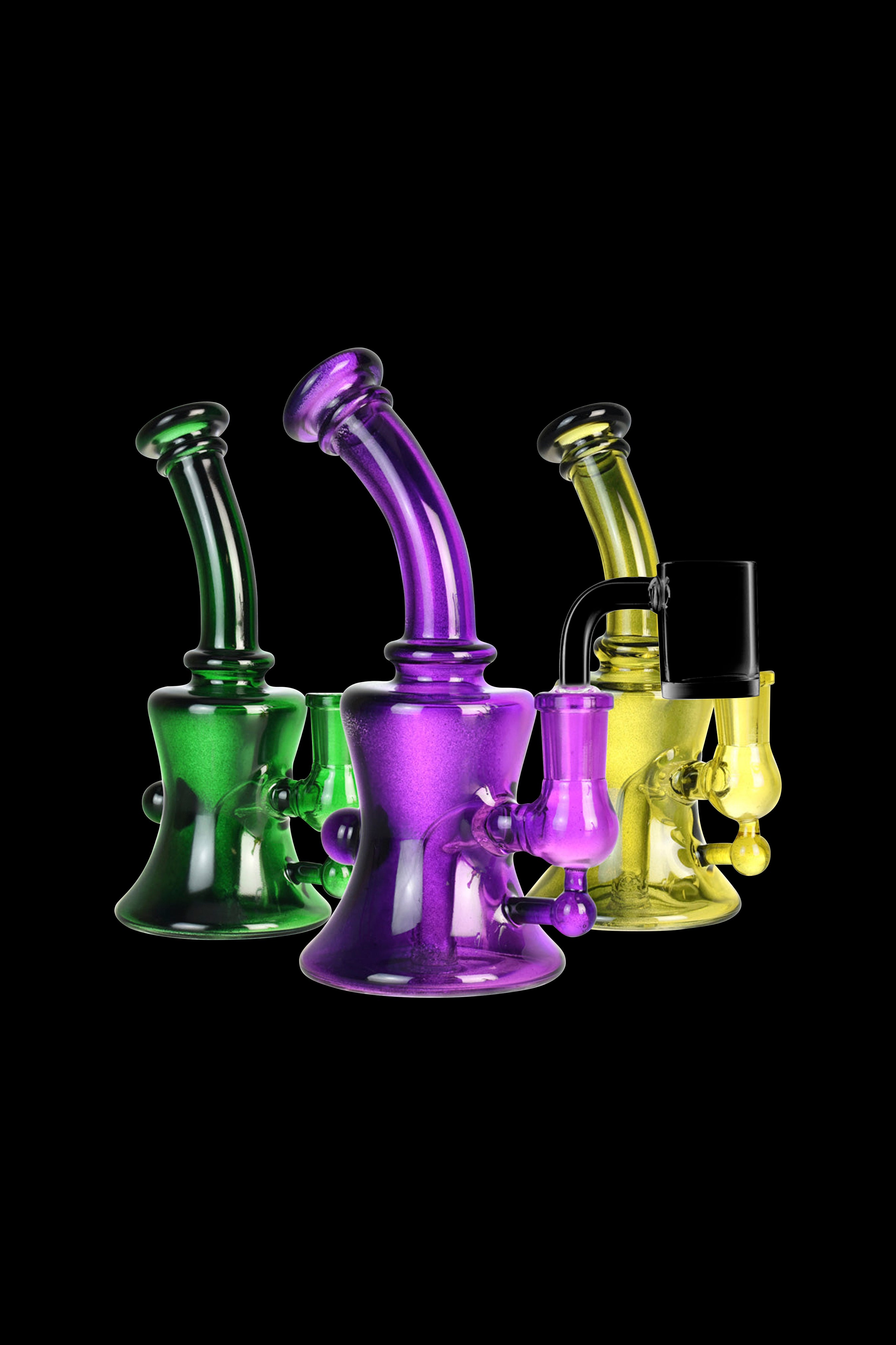 Three colorful glass water pipes (rigs) – green, purple, and yellow – against a black background.