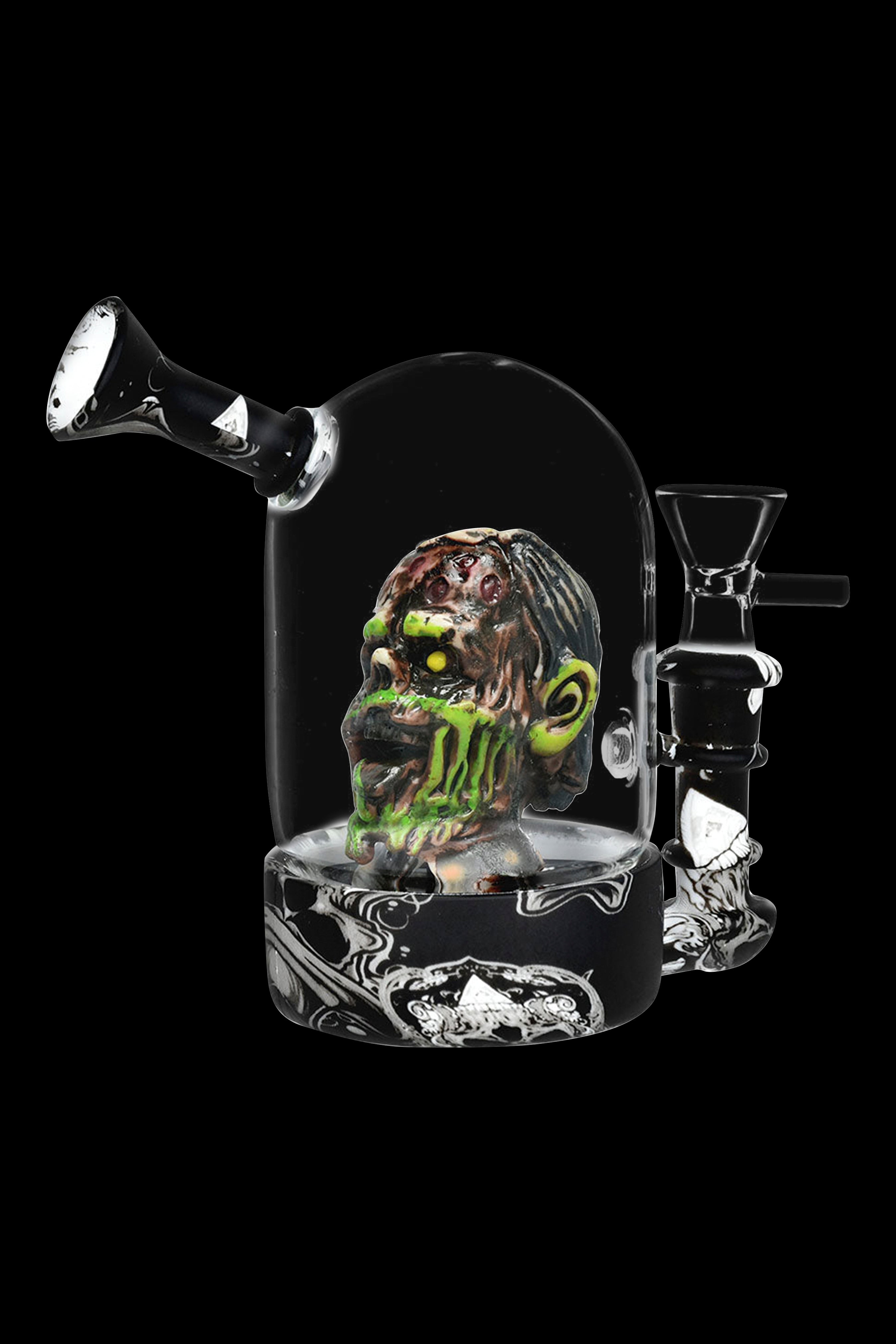 Glass water pipe featuring a sculpted, green and brown dreadlock-style skull within a clear glass enclosure, set against a black background.