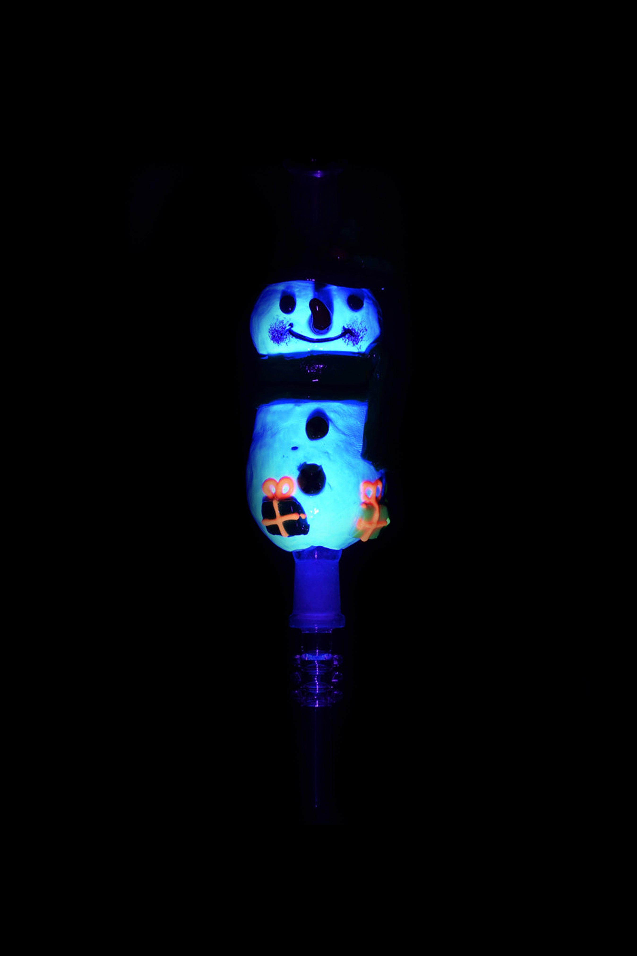 Glowing blue glass snowman-shaped water pipe against a black background.